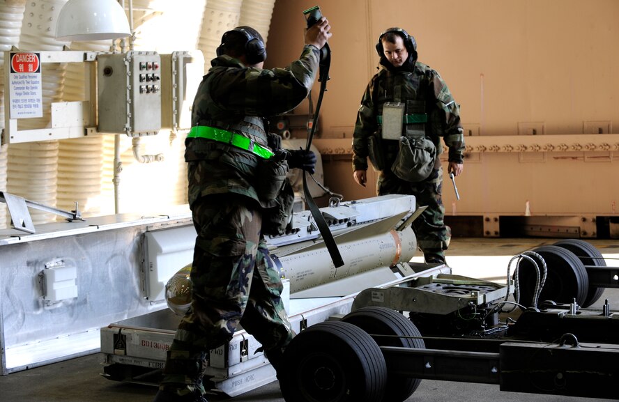 Staff Sgt. Nicholas Morin and Senior Airman Andre James unlatch a maverick missile, prepping it to be loaded onto an aircraft in a 25th Fighter Squadron hangar during exercise Beverly Midnight 09-02 on Osan Air Base, Nov. 2. (U.S. Air Force photo/ Senior Airman Stephenie Wade)