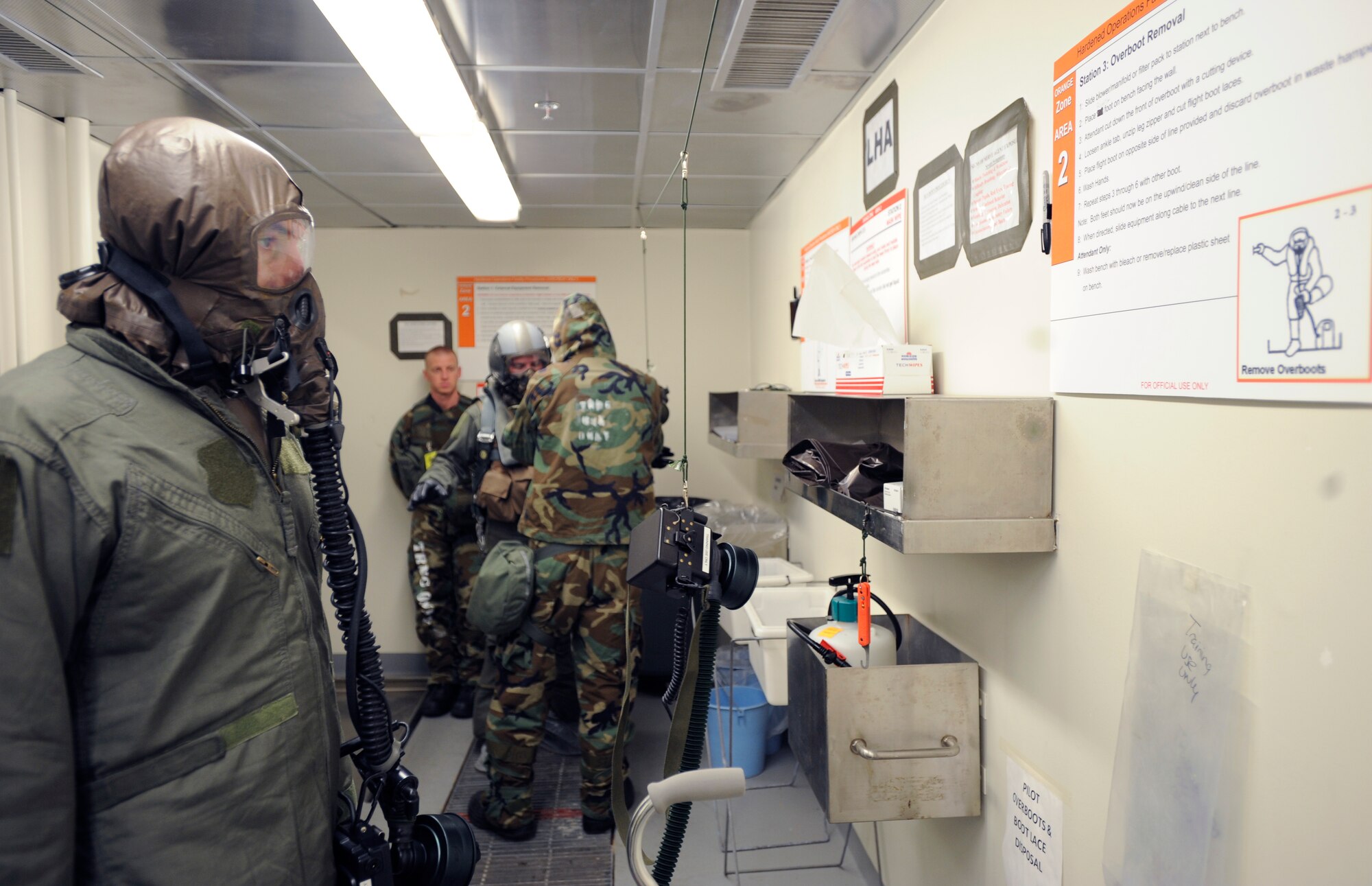 Lt. Col. Stephen Renner reads the instructions for the next step of his decontamination scenario at the 25th Fighter Squadron during exercise Beverly Midnight 09-02 on Osan Air Base, Nov. 2.  Colonel Renner is a pilot and the commander for the 25th FS. (U.S. Air Force photo/Senior Airman Stephenie Wade)