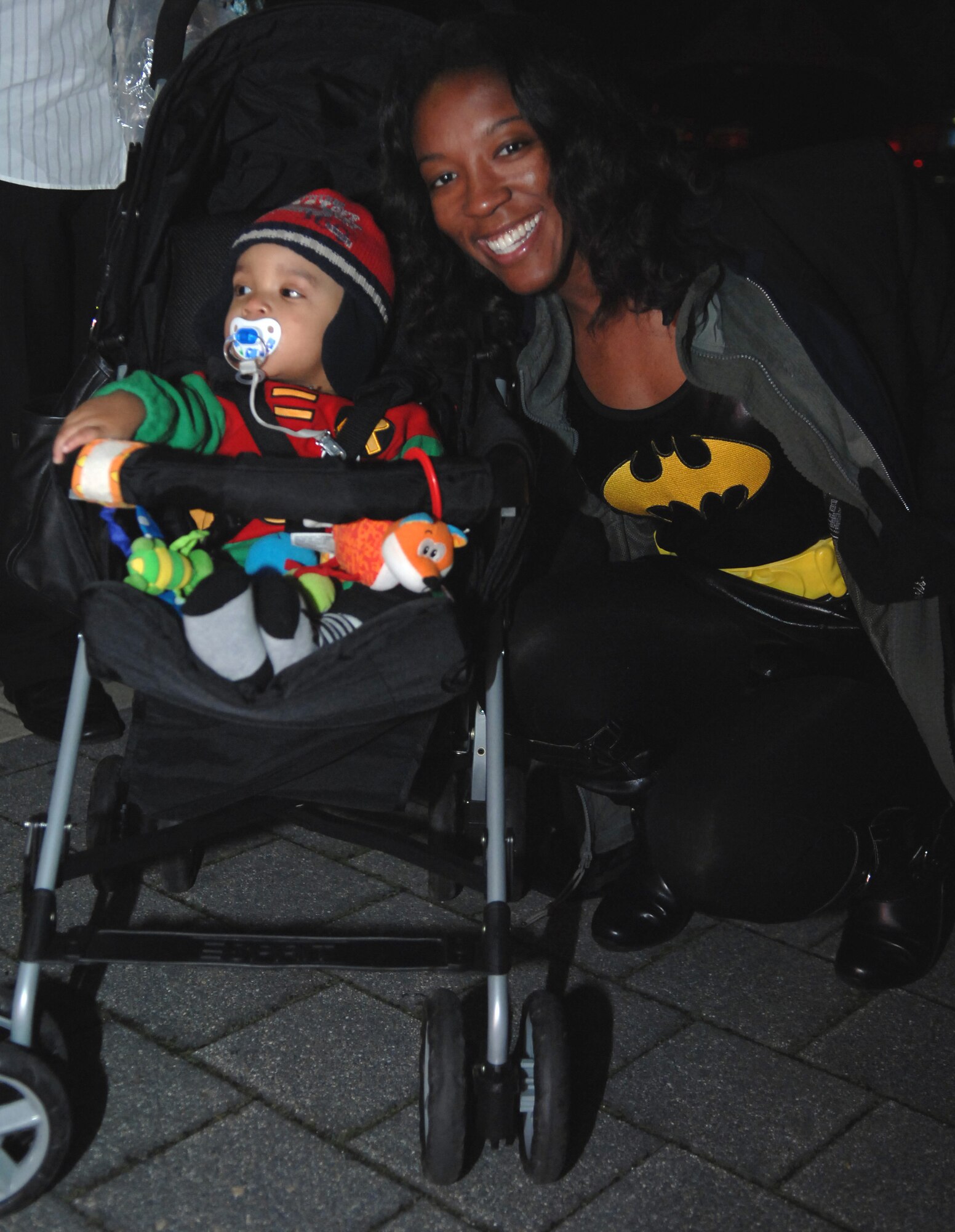 Xavier Isaiah Robinson, dressed as “Robin,” poses for a picture with his mom, Staff Sgt. Charity Barrett, 86th Airlift Wing public affairs photographer who dressed as "Batgirl," before heading out trick-or-treating, Oct. 31, 2009. Kaiserslautern Military Community servicemembers went house-to-house on Ramstein Air Base, as well as local German communities celebrating Halloween. (U.S. Air Force photo by Tech. Sgt. Michael Voss)