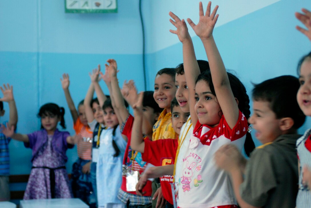 Children attending St. Efram Elementary School welcome soldiers to their classroom before being surprised with care packages Oct. 22, 2009, in Basra, Iraq. These children receive a culturally diverse education by attending one of the only two schools in Iraq to combine children of different religious denominations into one learning environment. U.S. Army photo by Spc. Stephanie Cassinos