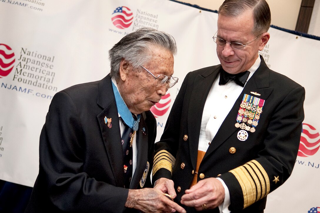 U.S. Navy Adm. Mike Mullen, chairman of the Joint Chiefs of Staff, speaks with Medal of Honor recipient George "Joe" Sakato at the 65th anniversary of the rescue of the "Lost Battalion" in Houston, Texas, Nov. 1, 2009. The event honored the 442nd Regimental Combat Team, a segregated unit comprised of mostly Japanese Americans. The unit rescued 230 men, lost more than 800 men in the battle and became the most decorated unit in U.S. military history.