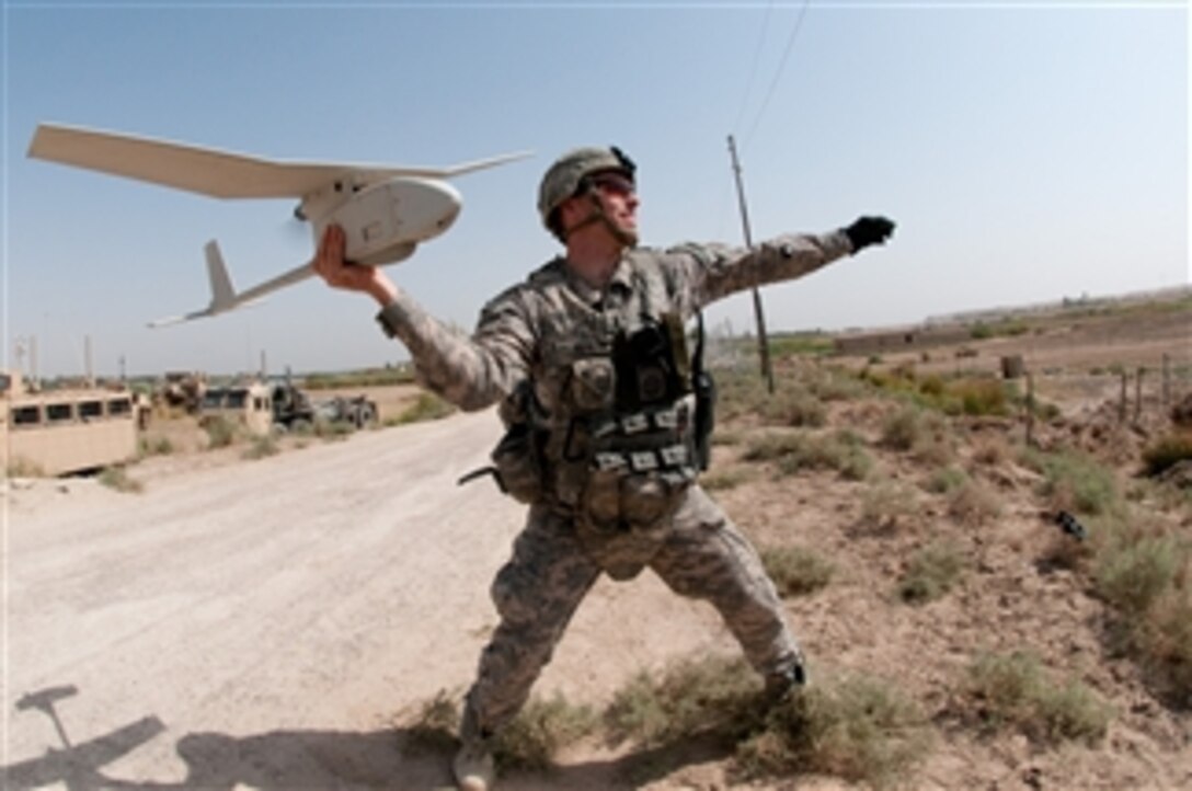 U.S. Army 1st Lt. Steven Rose launches an RQ-11 Raven unmanned aerial vehicle near a new highway bridge project along the Euphrates River north of Al Taqqadum, Iraq, on Oct. 9, 2009.  Rose is assigned to Charlie Company, 1st Battalion, 504th Parachute Infantry Regiment, 1st Brigade Combat Team, 82nd Airborne Division which is assisting Iraqi police in providing security for the work site.  