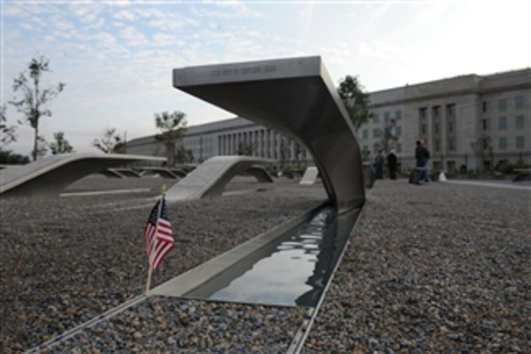 A small American flag stands near a bench at the Pentagon Memorial on Oct. 2, 2009.  