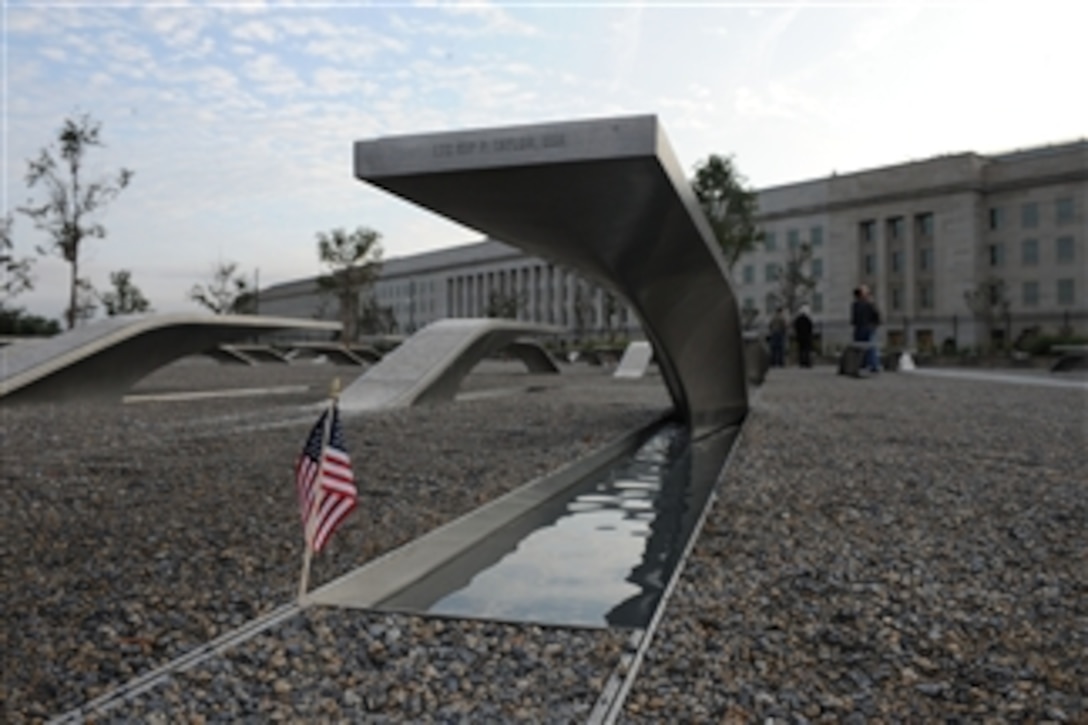 A small American flag stands near a bench at the Pentagon Memorial on Oct. 2, 2009.  