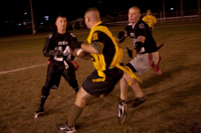 Five-O defensive linemen James Allen (left) and Ryan Casey (right) trap the Bats quarterback during an intramural flag football game at the Northside football field here Nov. 2. In the closing seconds, Five-O narrowly pulled out the victory 17-12.