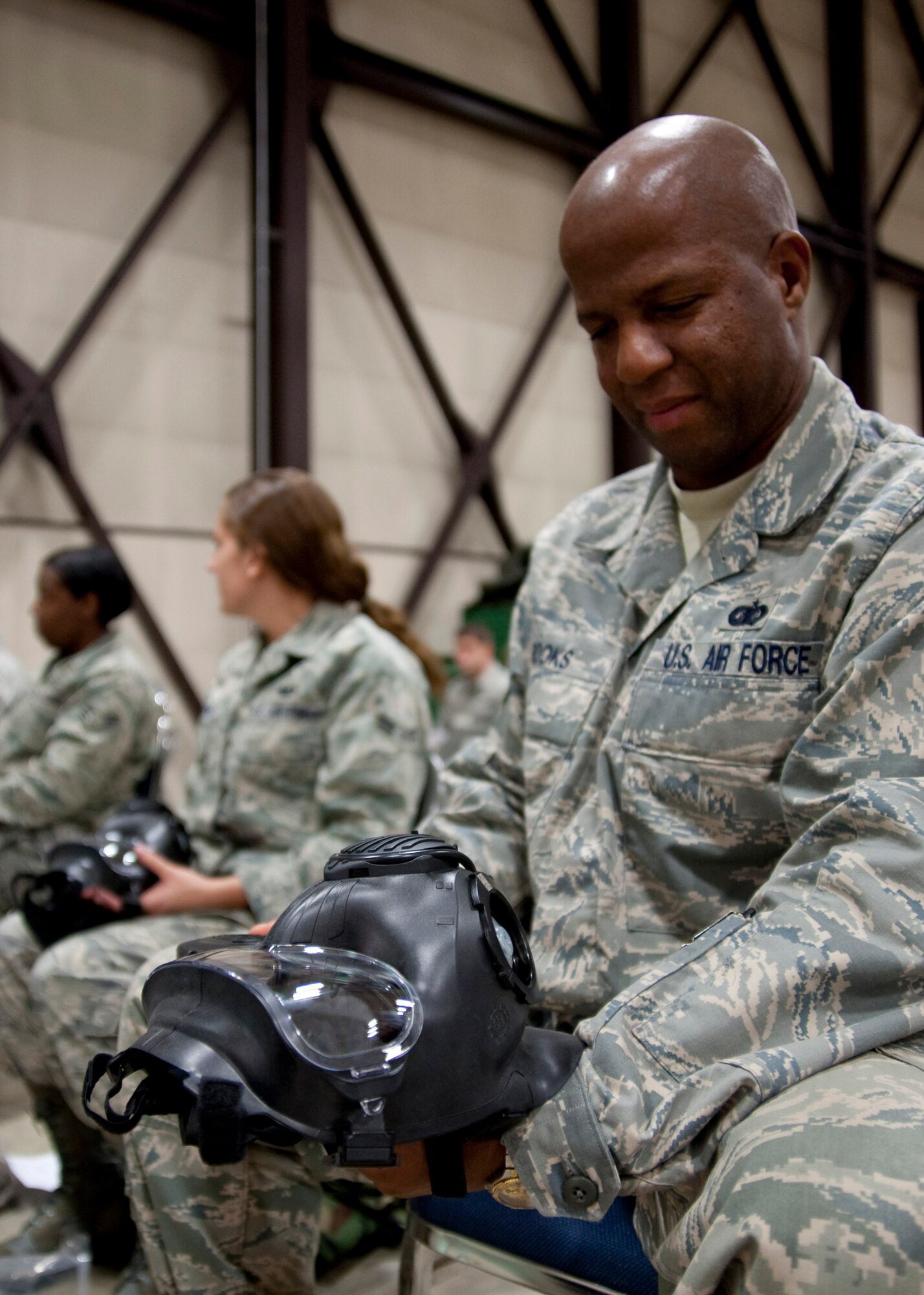 MISAWA AIR BASE, Japan -- Master Sgt. Mark Brooks, Misawa Security Operations Center knowledge operations management functional manager, inspects his new M-50 Joint Service General Purpose Mask in the 35th Logistics Readiness Squadron supply warehouse Nov. 3. Sergeant Brooks compared this new mask to previous models saying, "We've come a long way." (U.S. Air Force photo/Staff Sgt. Samuel Morse)