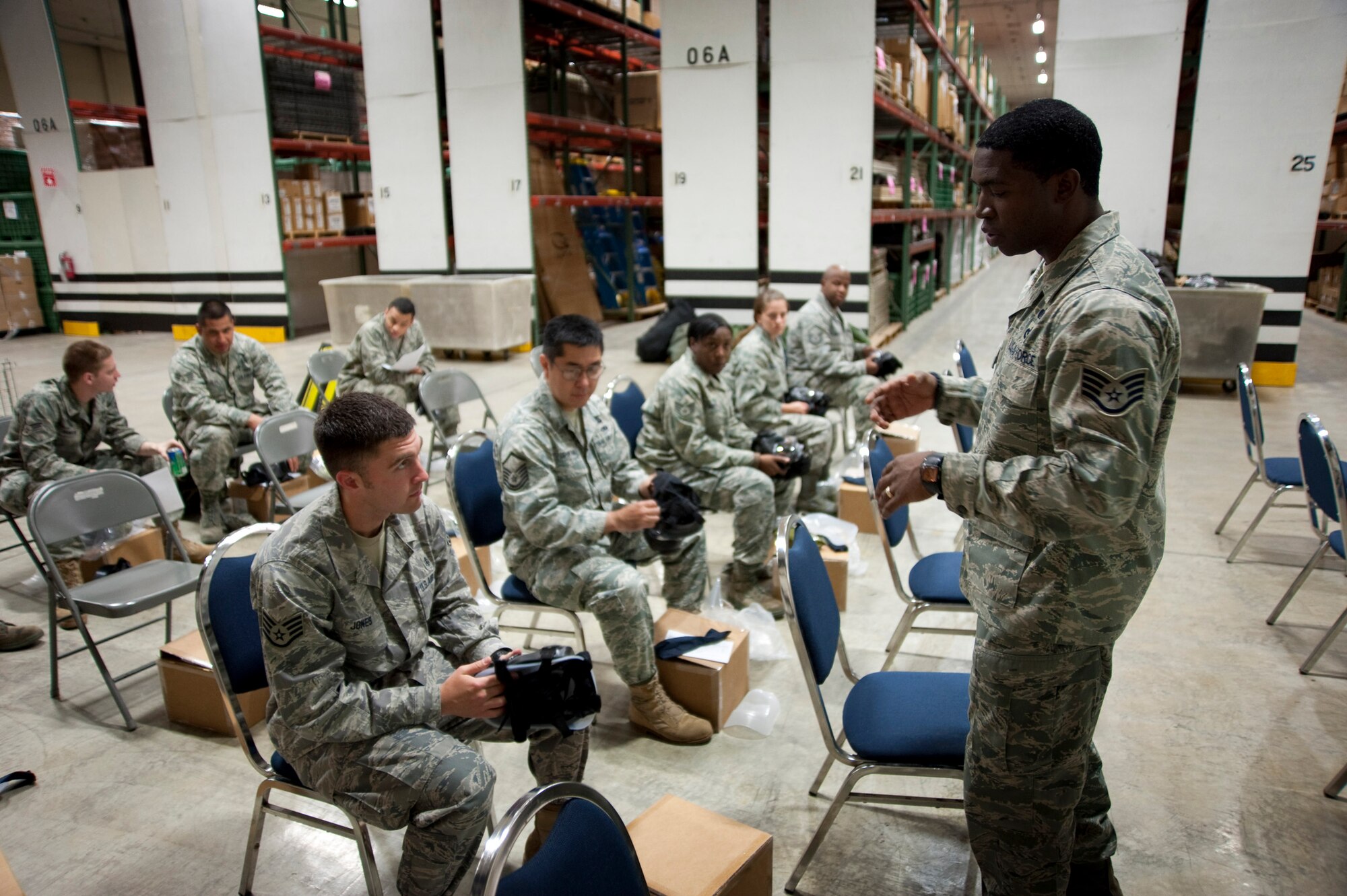 MISAWA AIR BASE, Japan -- Staff Sgt. Mikel Rogers, 35th Civil Engineer Squadron readiness and emergency management flight operations NCO in charge, guides a group of Airmen through unpacking and assembling their new M-50 Joint Service General Purpose Mask in the 35th Logistics Readiness Squadron supply warehouse Nov. 3. The new model has two filters that can be changed while worn in a contaminated environment. (U.S. Air Force photo/Staff Sgt. Samuel Morse)