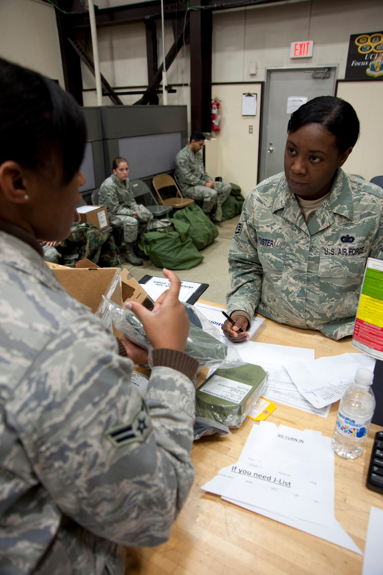 MISAWA AIR BASE, Japan -- Airman 1st Class Randi Smith, 35th Logistics Readiness Squadron supply apprentice, issues a new M-50 Joint Service General Purpose Mask to Staff Sgt. Diane Foster, 35th Maintenance Group knowledge operations manager, at the 35th LRS supply warehouse Nov. 3. The 35th LRS created a one-stop shop for gas mask turn-in, issue, training and fit testing. (U.S. Air Force photo/Staff Sgt. Samuel Morse)