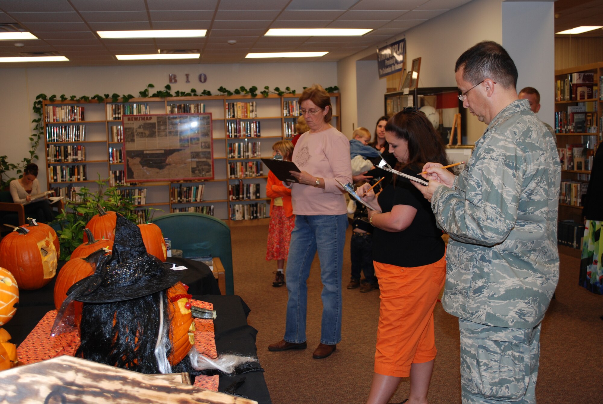Connie Lisowski, Lori Cargile, and Chaplain Charles Montoya judged the Base Library's annual pumpkin carving contest Thursday.  The winning squadron entry was submitted by the FSS squadron and carved by Peggy Guenther and Lt Jonathan Murphy and the winning family entry was submitted by Linda Norman, Bowling Center snack bar supervisor. (U.S. Air Force photo/Pam Wickham)