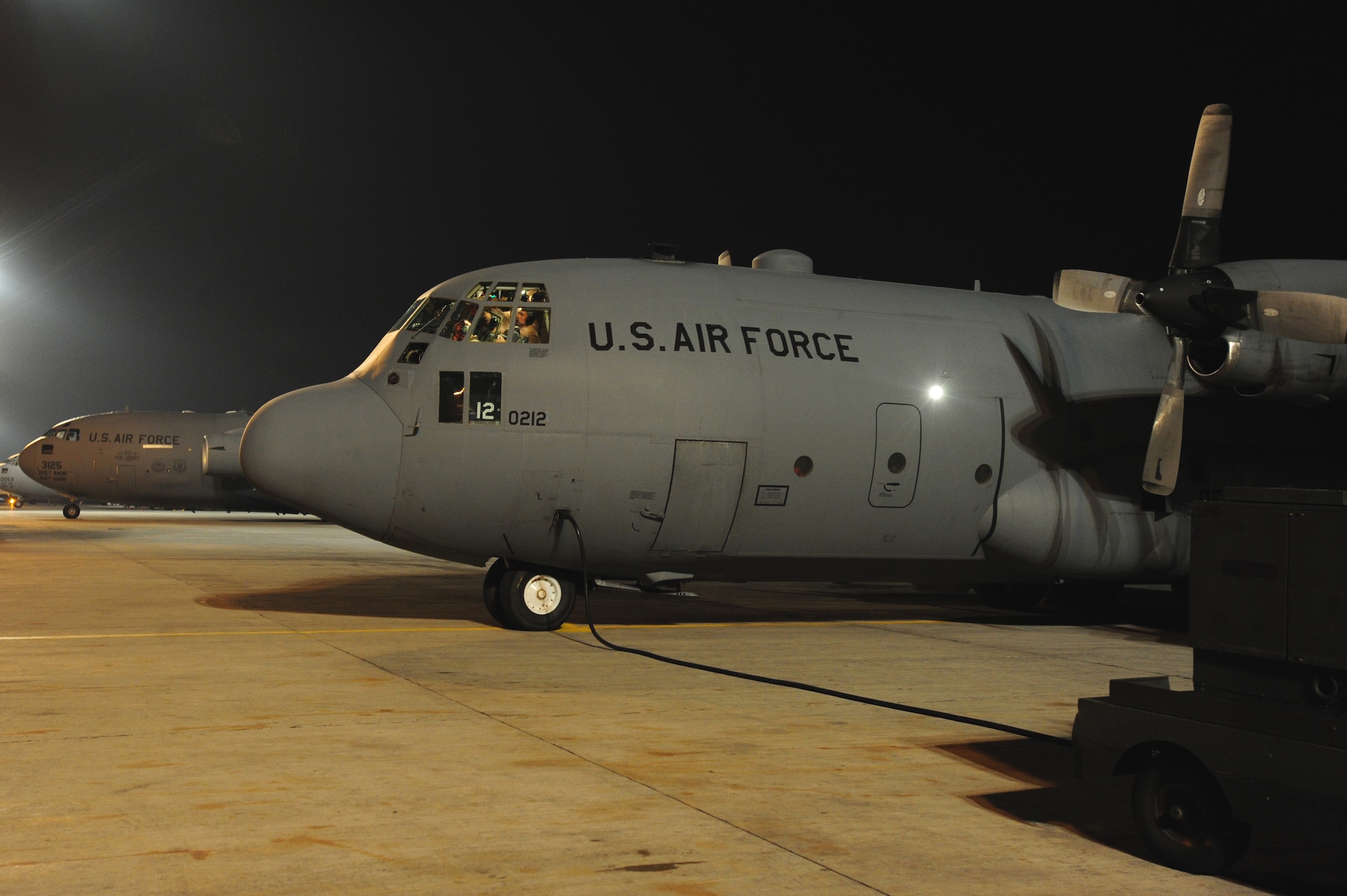 TRANSIT CENTER AT MANAS, Kyrgyzstan -- A C-130 Hercules parks after taxiing at the Manas International Airport. The 'Herk' and it's crew were carrying out the mission of onward troop movement in support of Operation ENDURING FREEDOM while at Manas. (U.S. Air Force photo/Senior Airman Steele C. G. Britton)