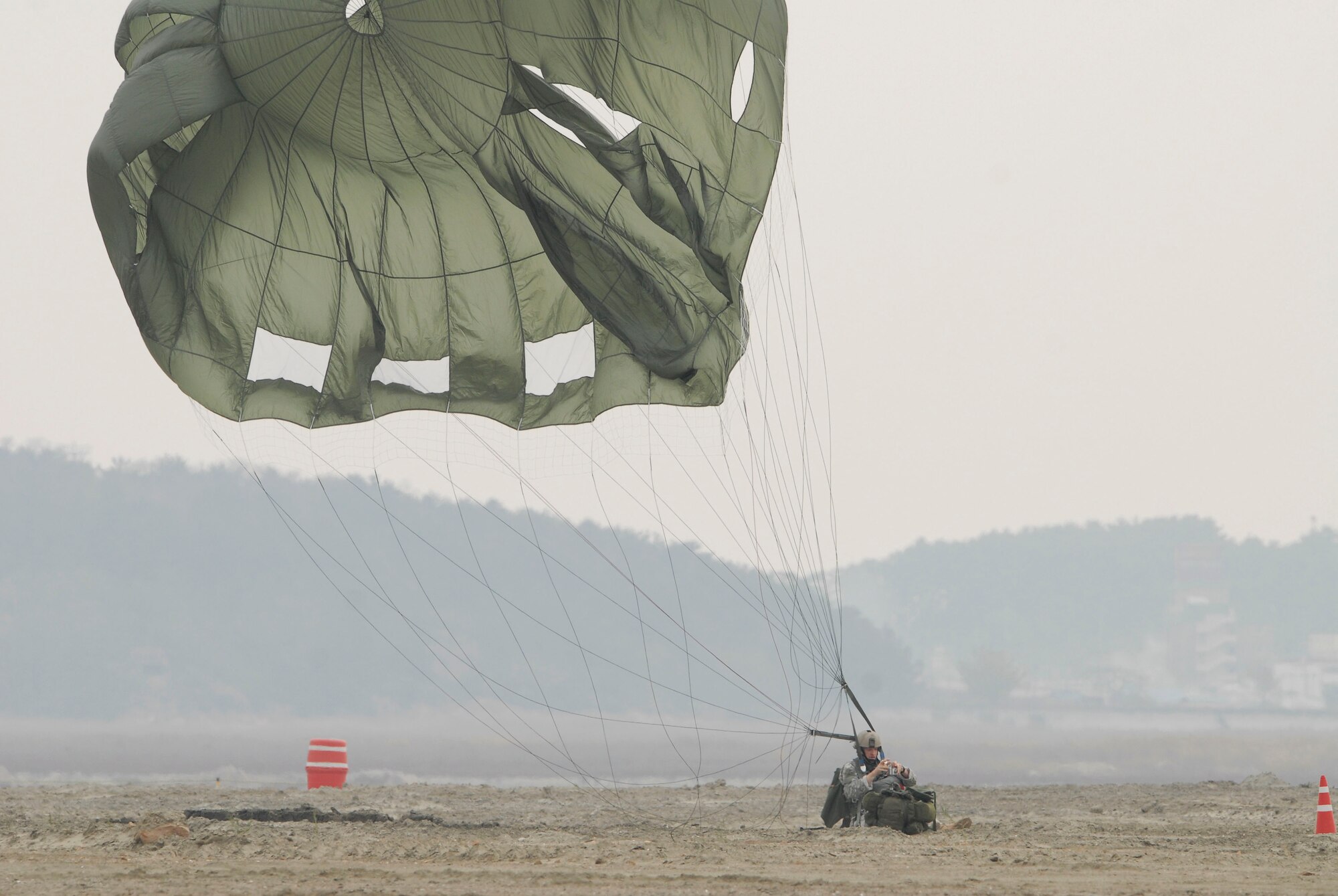 KUNSAN AIR BASE, Republic of Korea -- A parachutist takes a photo of fellow parachutist after his jump during the Gunsan Saemangeum Airshow in Gunsan City. The City of Gunsan, the 8th Fighter Wing and the Republic of Korea Air Forces' 38th Fighter Group hosted the air show, Oct. 31. (U.S. Air Force photo/Staff Sgt. Darnell T. Cannady)