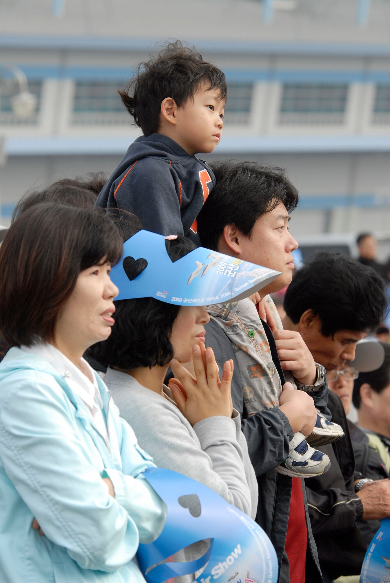 KUNSAN AIR BASE, Republic of Korea -- A Korean family watches the Republic of Korea honor guard perform during the opening ceremony of the Gunsan Saemangeum Airshow in Gunsan City. The City of Gunsan, 8th Fighter Wing and Republic of Korea Air Forces' 38th Fighter Group hosted the Air Show in Gunsan City, Oct. 31. (U.S. Air Force photo/Staff Sgt. Darnell T. Cannady)