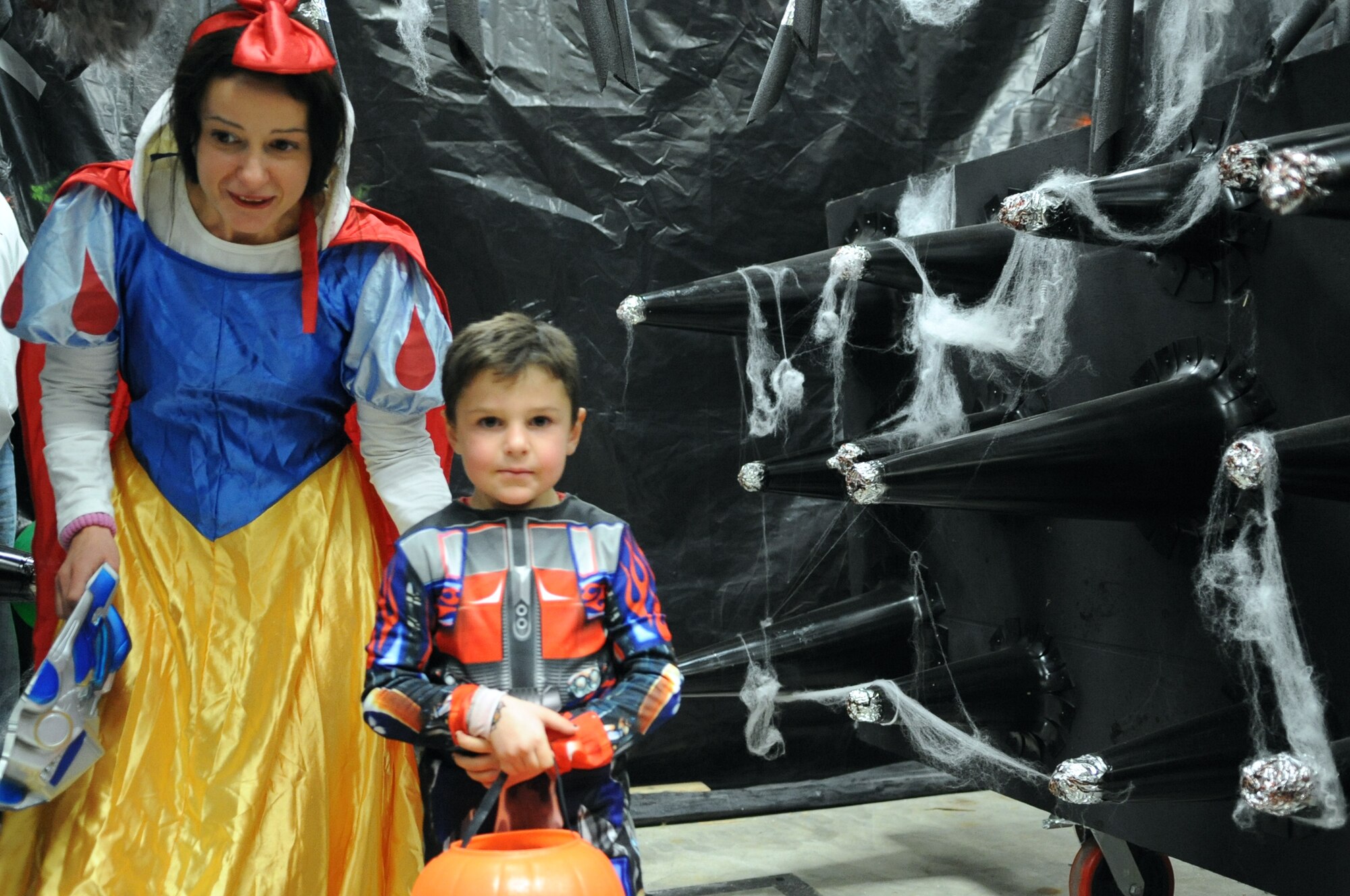 BUCKLEY AIR FORCE BASE, Colo. -- Snow White and Optimus Prime brave the spider-infested room of spikes at the 460th Civil Engineer Squadron "Slaughter House" Oct. 31. (U.S Air Force photo by Airman 1st Class Paul Labbe)