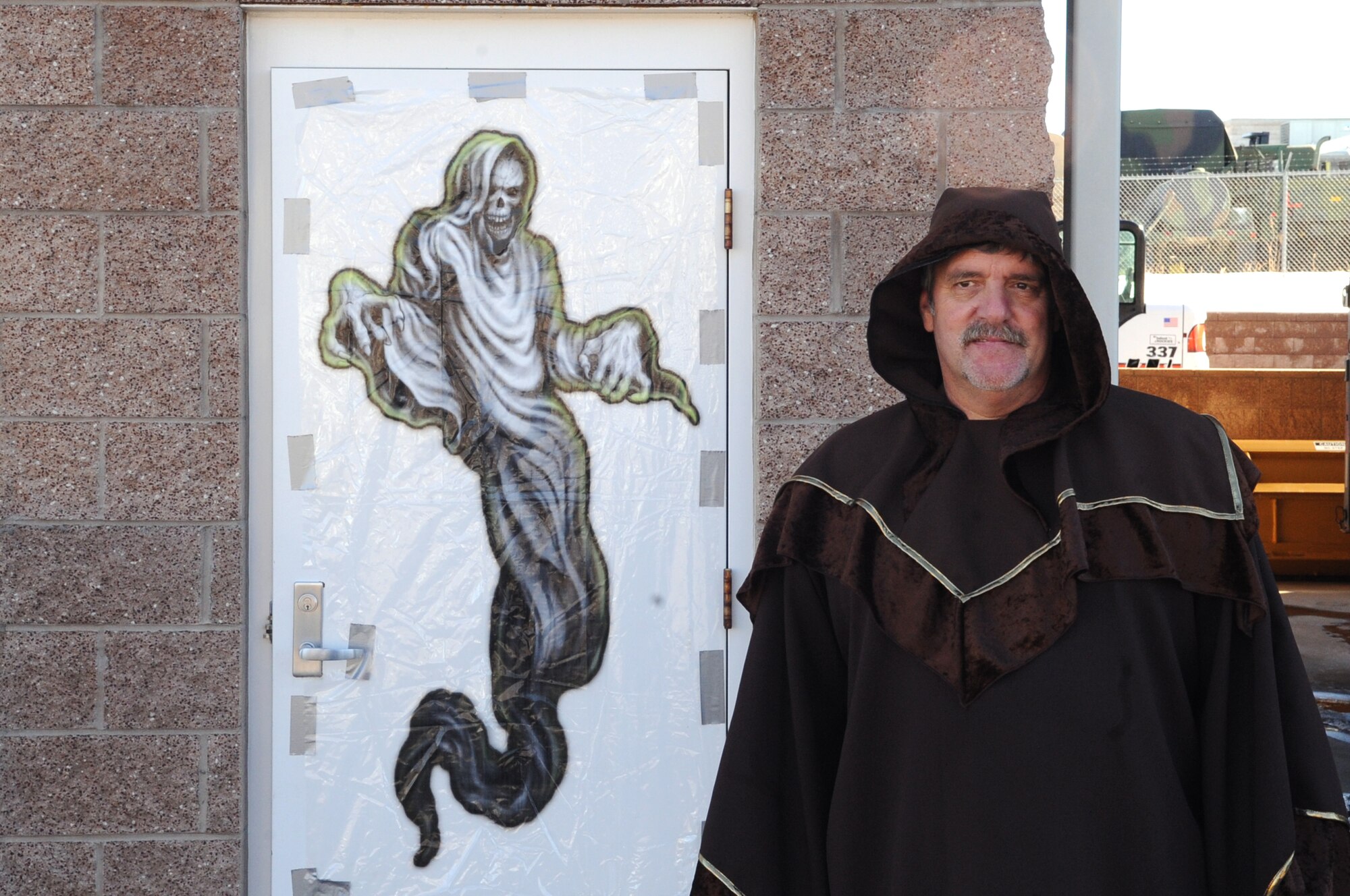 BUCKLEY AIR FORCE BASE, Colo. -- A worker at the 460th Civil Engineer Squadron Halloween "Slaughter House" guards the entrance to the tour of horrors. The 460th CES hosted the haunted house for military members and their families in late October. (U.S Air Force photo by Airman 1st Class Paul Labbe)