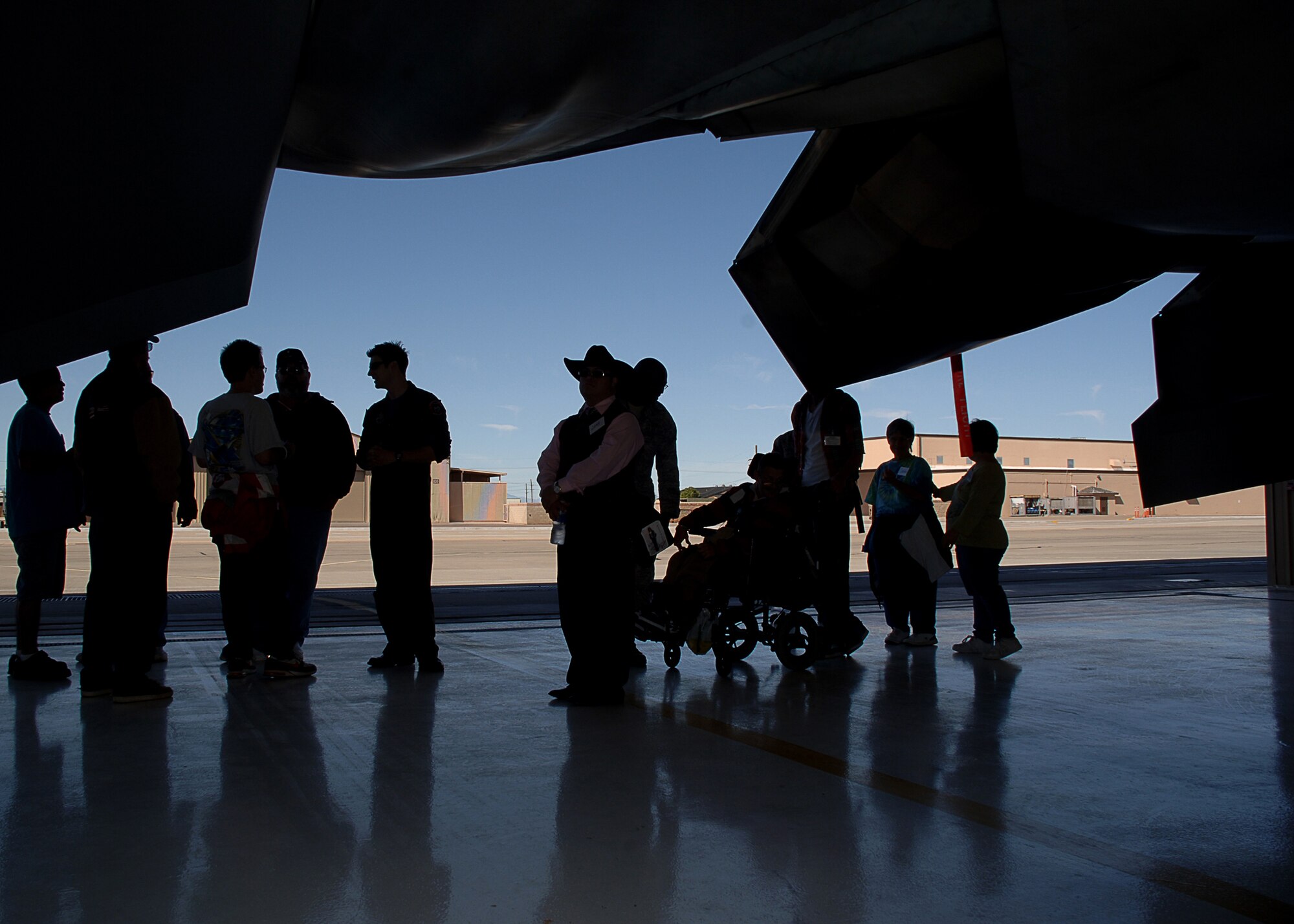 HOLLOMAN AIR FORCE BASE, N.M. -- Special guests to the base from Zia Therapy Center and Otero County Special Olympics tour an F-22A Raptor here Oct. 23. The tour was part of a special day where the guests were invited to visit the base and tour the F-22, the Holloman Fire Department and watch an exclusive air show open only to base personnel. (U.S. Air Force photo by Staff Sgt. Sanjay Allen)