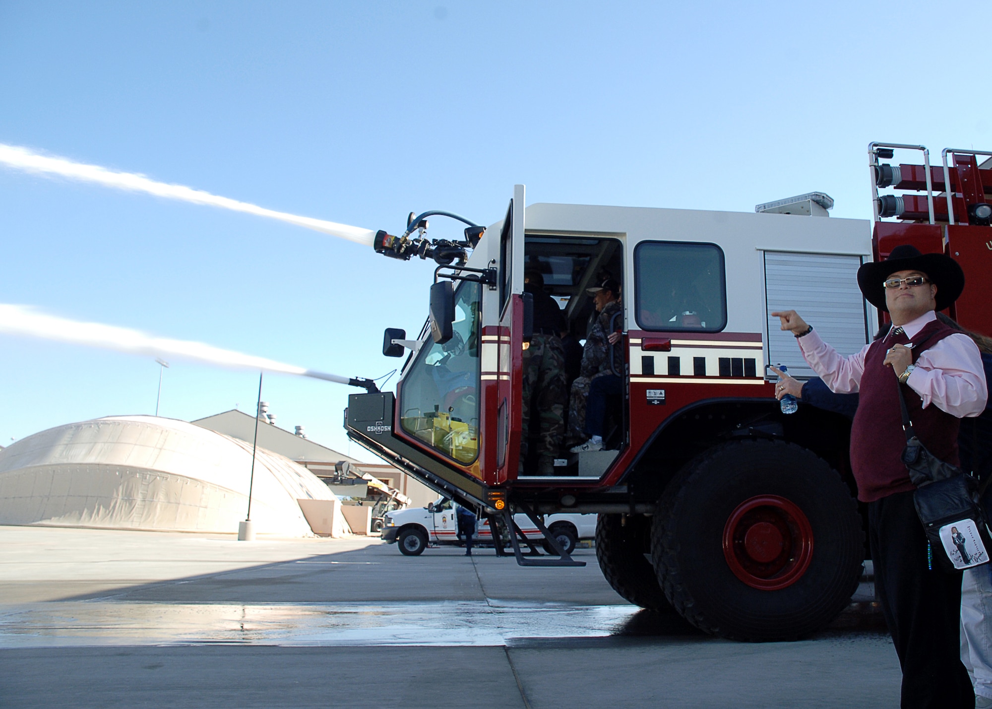 HOLLOMAN AIR FORCE BASE, N.M. -- Joey, a tour patron, points out the capability of one of Holloman Fire Department?s fire engines to other members of his tour here Oct. 23. Special needs people from Zia Therapy Center and Otero County Special Olympics toured the fire department, an F-22A Raptor and were also treated to an exclusive air show open only to base personnel. (U.S. Air Force photo by Staff Sgt. Sanjay Allen)