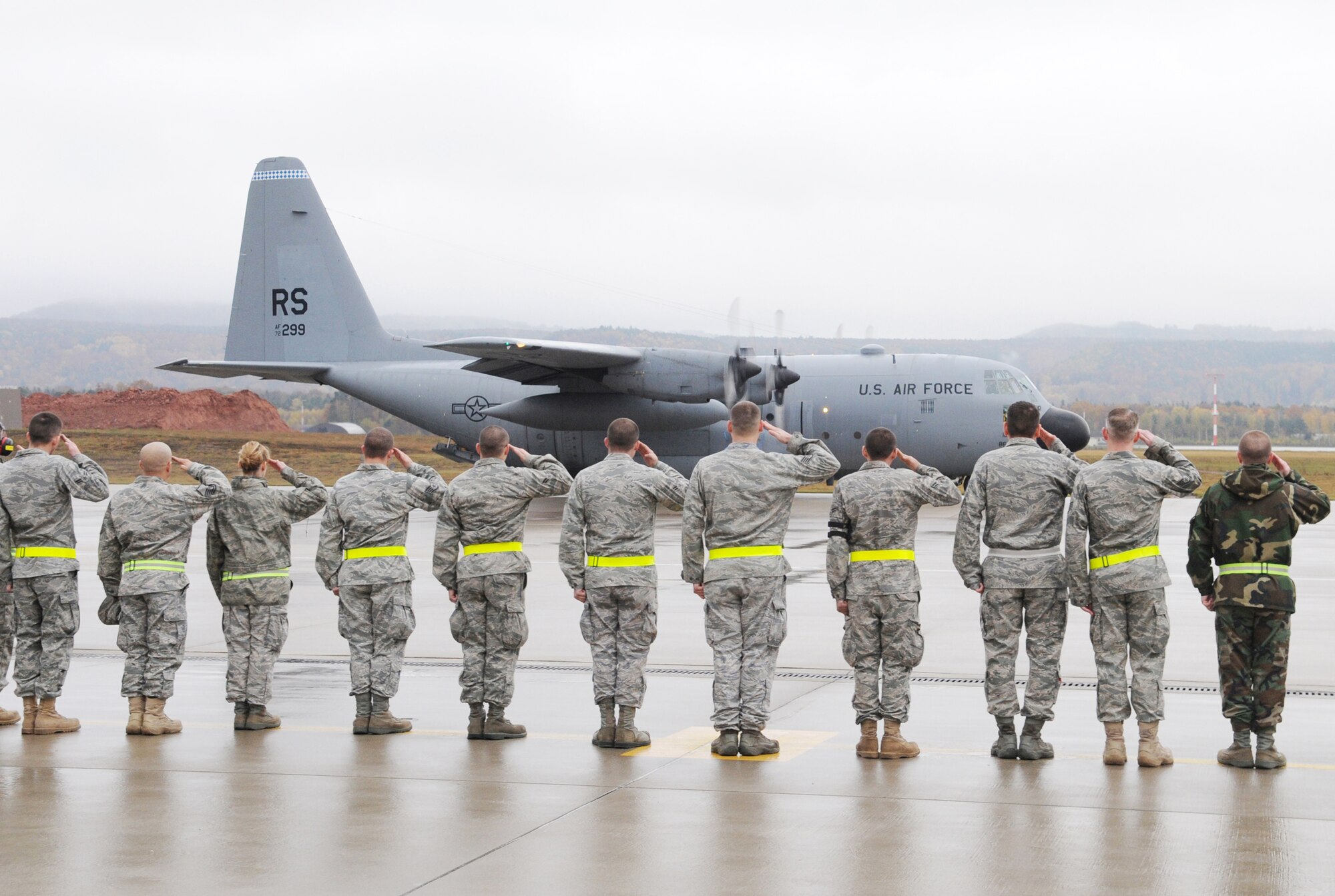 Airmen from the 86th Aircraft Maintenance Squadron at Ramstein Air Base, Germany, render a salute to the last C-130E Hercules as it taxies down the flightline Nov. 2, 2009, for departure.  The E-model Hercules aircraft have provided more than 40 years of airpower to bases in the United States Air Forces in Europe, and are being replaced by the newer C-130J Super Hercules as part of revitalizing the Air Force fleet. (U.S. Air Force photo/Airman 1st Class Caleb Pierce)