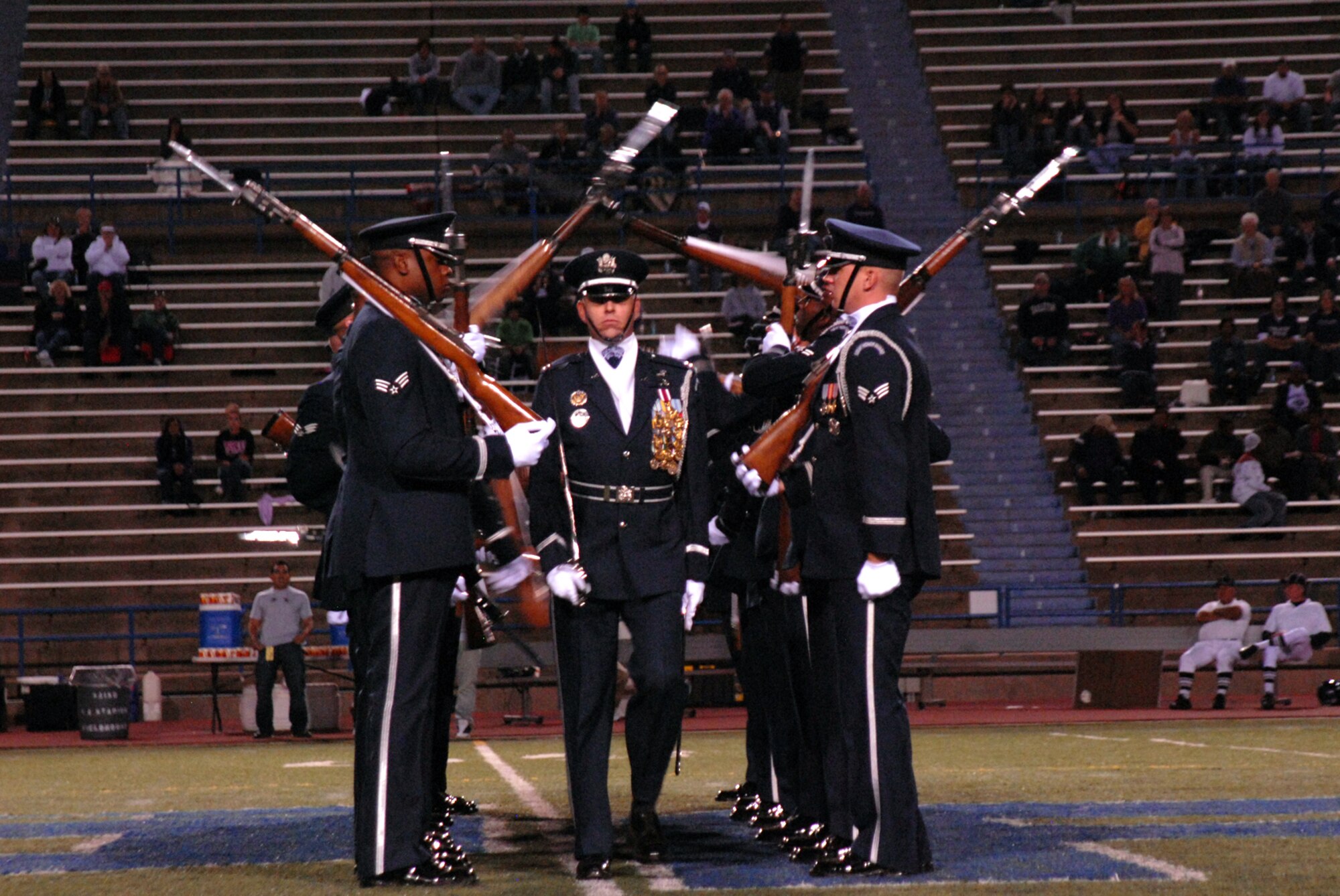 Capt. Michael Fanton walks the “gauntlet” during the U.S. Air Force Honor Guard Drill Team performance at the Angelo State University football game half-time show, Oct. 31, 2009. The Drill Team is the traveling component of the U.S. Air Force Honor Guard and tours worldwide representing all Airmen while showcasing Air Force precision and professionalism. (U.S. Air Force photo/Staff Sgt. Laura R. McFarlane)