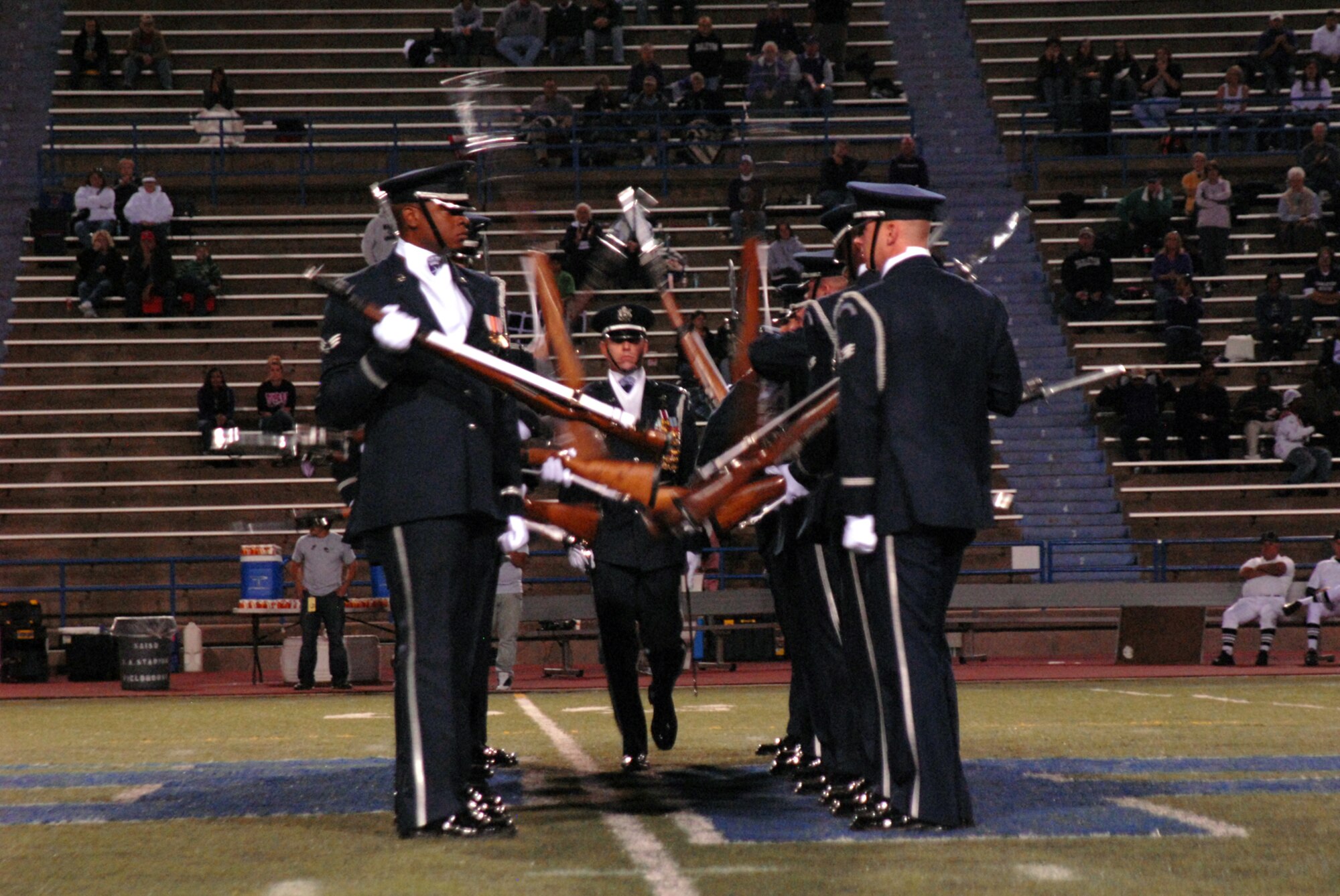 Capt. Michael Fanton walks the “gauntlet” during the U.S. Air Force Honor Guard Drill Team performance at the Angelo State University football game half-time show, Oct. 31, 2009. The Drill Team is the traveling component of the U.S. Air Force Honor Guard and tours worldwide representing all Airmen while showcasing Air Force precision and professionalism. (U.S. Air Force photo/Staff Sgt. Laura R. McFarlane)