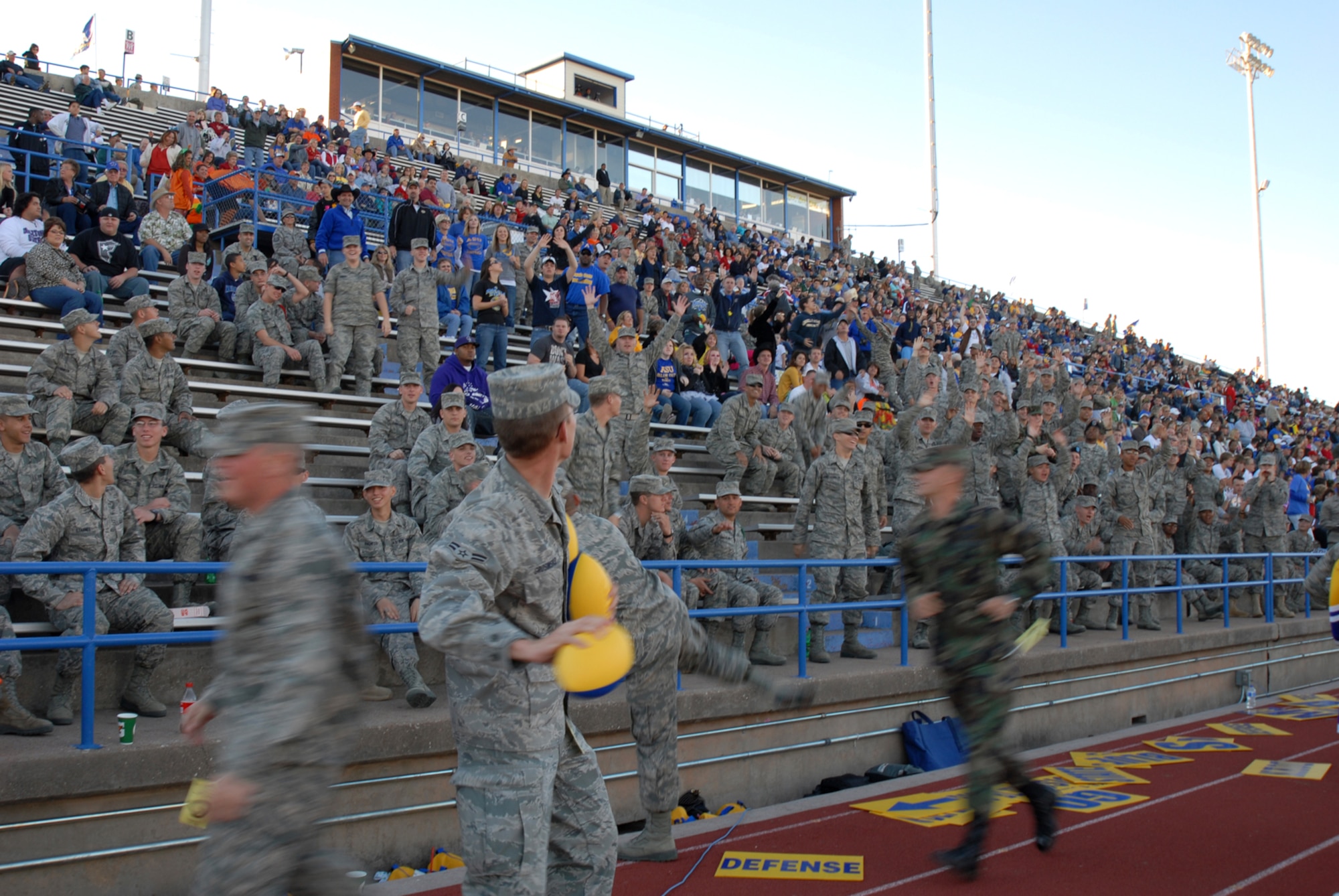 Airmen from Goodfellow Air Force Base throw footballs into the crowd during an Angelo State University football game, Oct. 31, 2009.  ASU offered free admission to all active, reserve, guard and retired military in recognition of military appreciation day. (U.S. Air Force photo/Staff Sgt. Laura R. McFarlane)