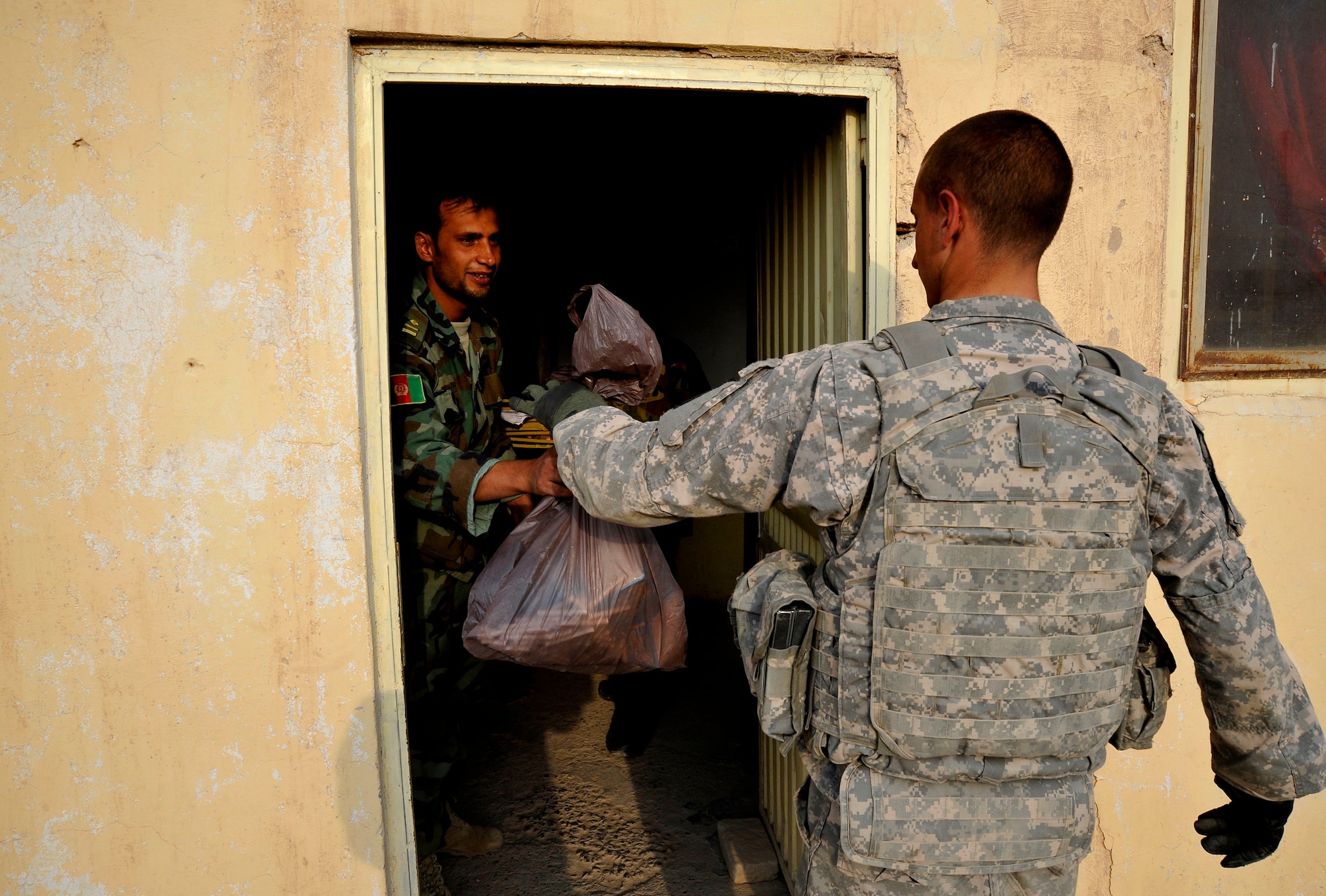 U.S. Army Pfc. James Daws delivers school supplies to Afghan soldiers Oct. 27, 2009, in Qalat, Afghanistan. Private Daws is a security forces member of the Zabul Provincial Reconstruction Team. (U.S. Air Force photo/Staff Sgt. Angelita Lawrence)
