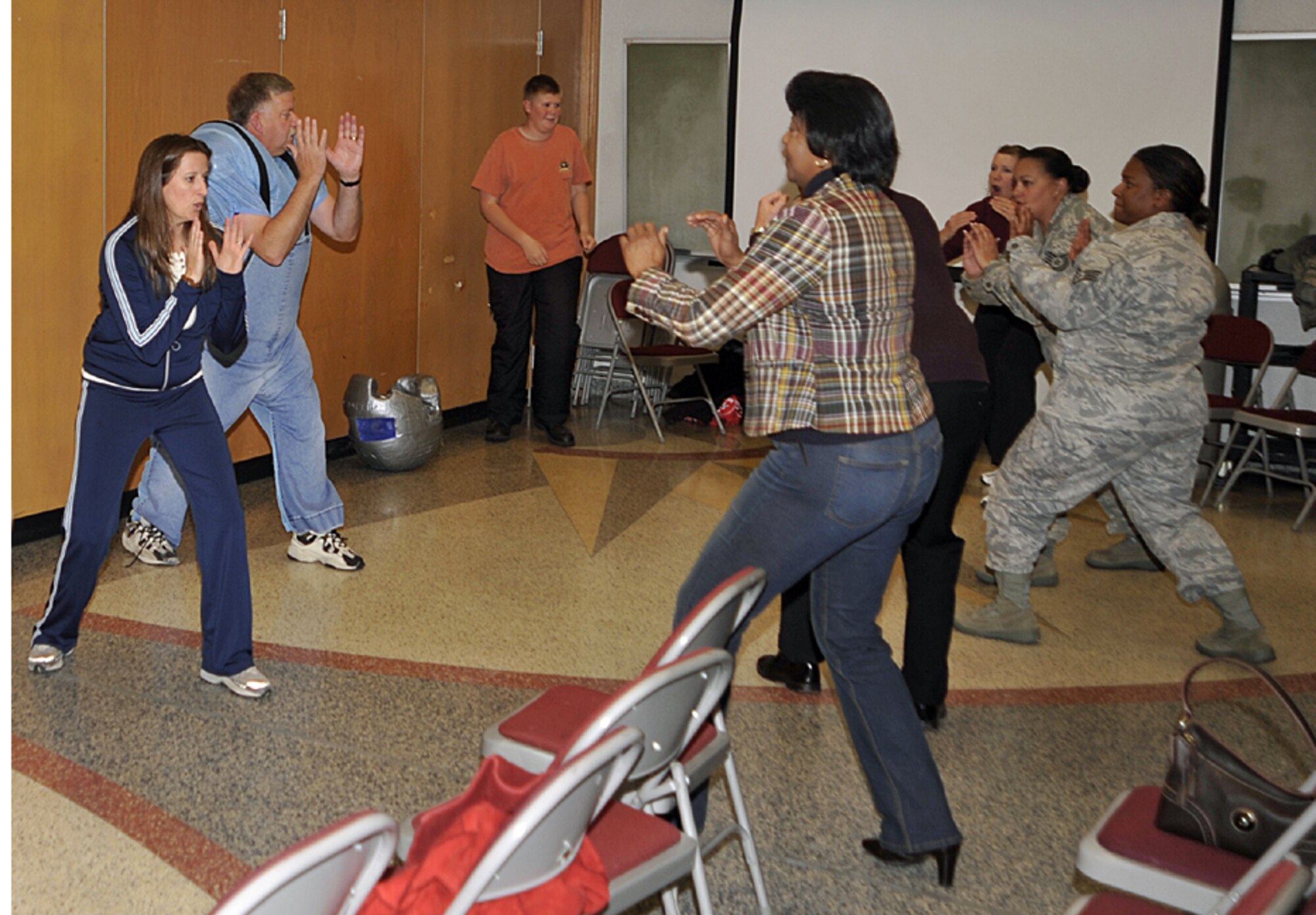 Sam Rush-Walton, Full Power director, and Karl Herndon, El Paso County Sheriff’s Office deputy (center), teach self defense techniques at Peterson Oct. 29 to Airmen and their families. Full Power's two-hour class was sponsored by the 21st Space Wing's Sexual Assault Response Coordinator. Ms. Rush-Walton and Mr. Herndon teach students how to be aware of their surroundings, personal safety, and how to defuse a potential incident before it occurs. (Air Force photo by Dennis Howk)