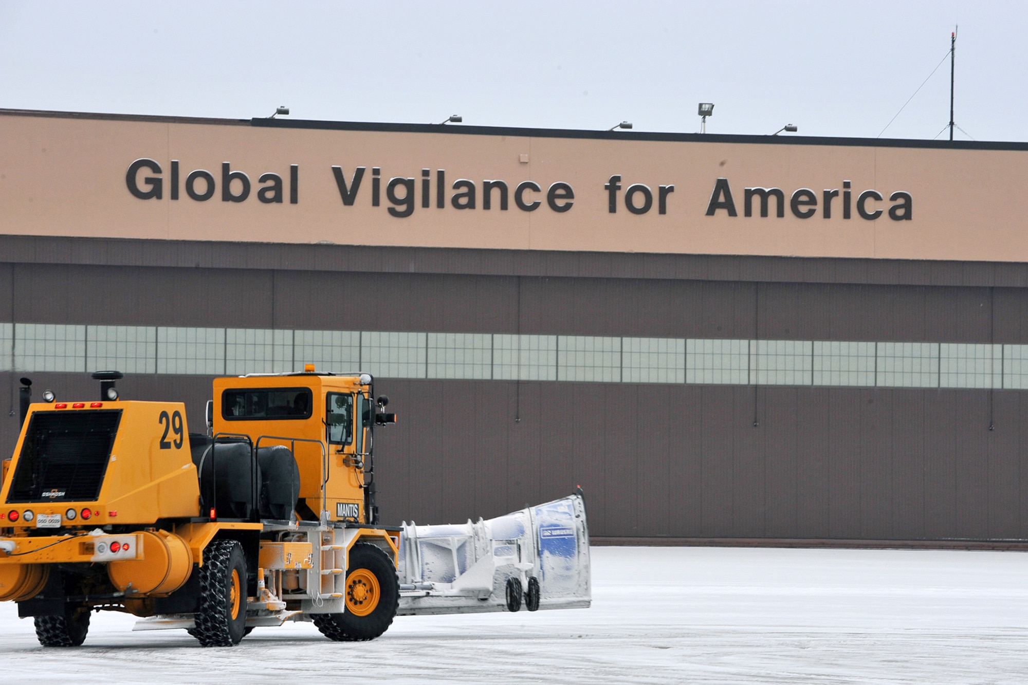OFFUTT AIR FORCE BASE, Neb., -- A member of the 55th Civil Engineering Squadron, clears snow on the flight line here January 12. During the winter months, Nebraska residents can experience some harsh conditions. With this in mind, members of Team Offutt are encouraged to call the Snow and Information Line at 232-COLD to get the latest news on official delayed reporting and base closures. U.S. Air Force Photo by Charles Haymond