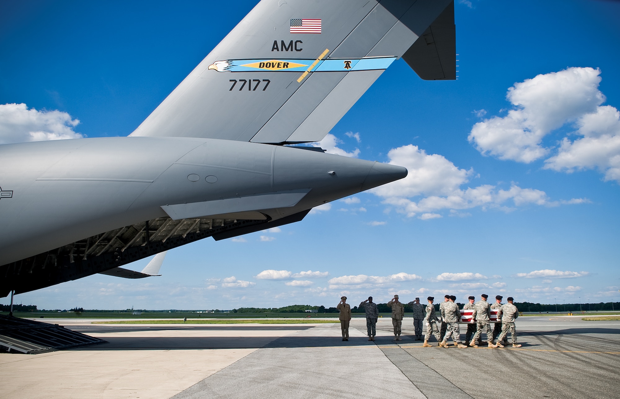 Chairman of the Joint Chiefs of Staff Admiral Michael Mullen, Army Brig. Gen. Michael Harrison, Rear Adm. James Shannon and Air Force Col. Manson Morris render a solemn salute during the dignified transfer of a fallen warrior at Dover Air Force Base, Del., July 8, 2009. All fallen service members are transferred directly from the combat theater to the Air Force Mortuary Affairs Operation Center at Dover AFB where they are carefully prepared for return to their families. (DoD photo/Benjamin Faske)