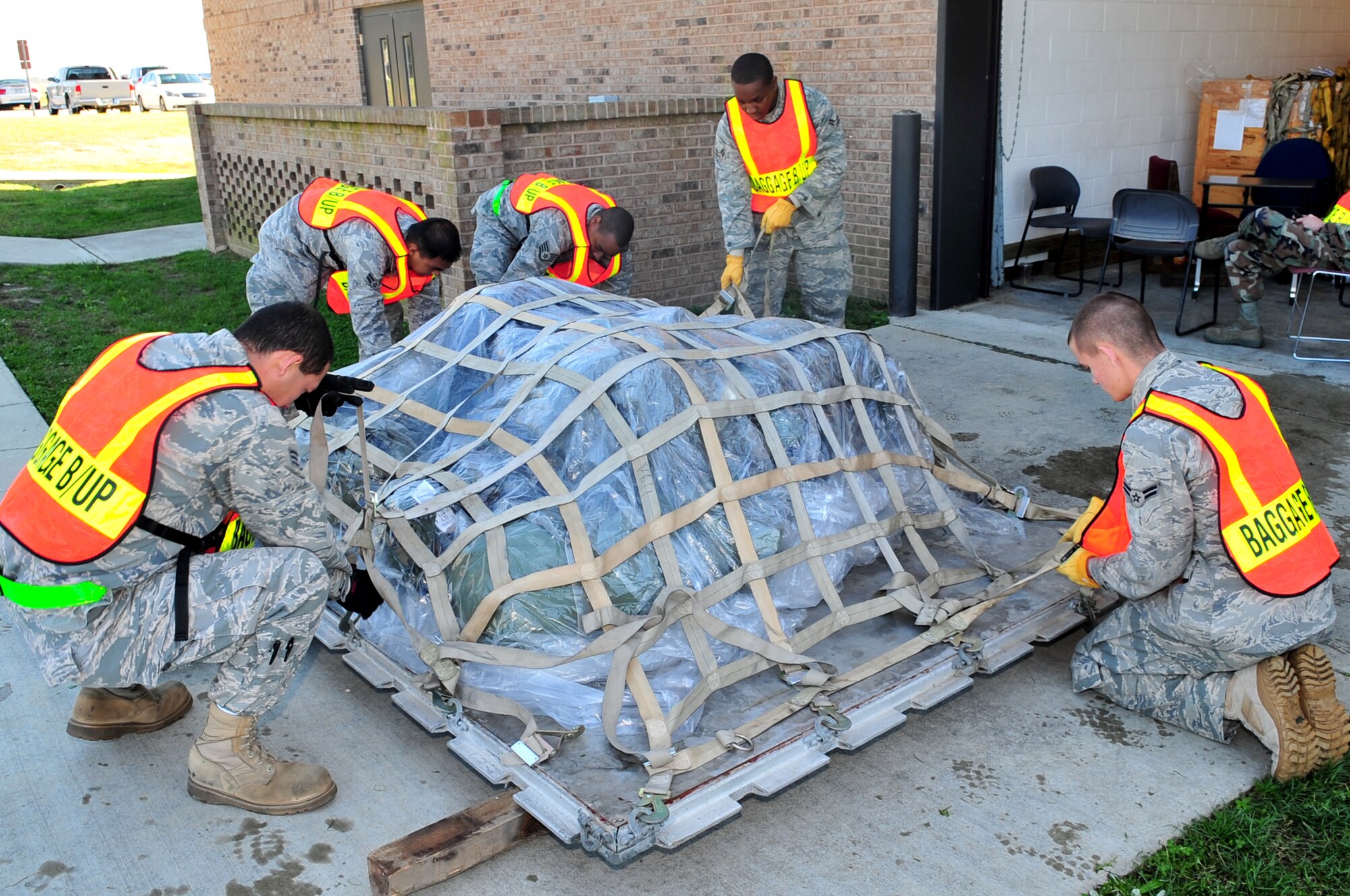 Airmen from the 4th Logistic Readiness Squadron secure personal bags during the 4th Mission Support Group Phase I exercise on Seymour Johnson Air Force Base, N.C., Nov. 3, 2009. The Phase I exercise tests the ability of Airmen to deploy on short notice with the proper equipment and updated deployment records. (U.S. Air Force photo/Airman 1st Class Rae Perry)