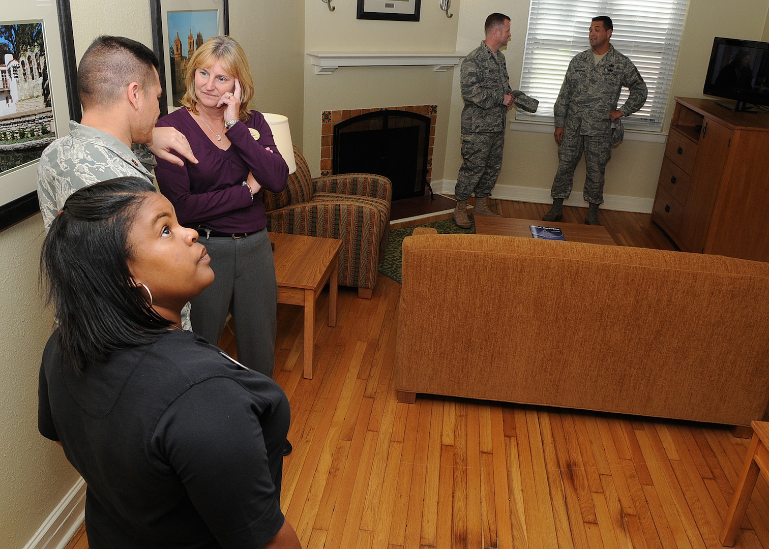 The living room of a recently renovated Temporary Lodging Facility is inpected by guests after a Nov. 3 ribbon cutting ceremony opening the facility at Randolph Air Force Base, Texas. (U.S. Air Force photo by David Terry)