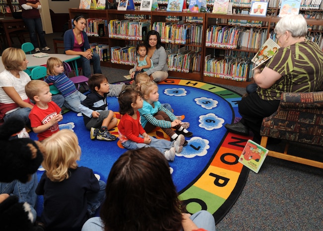 Angela Bevins reads a story to a group of children at the base library here Nov. 3. The library held a family themed story hour by reading "Me and My Family" and "Clifford's Family" in support of Air Force Family Week. Ms. Bevins is a circulation technician with the 437th Force Support Squadron. (U.S. Air Force photo/Senior Airman Katie Gieratz)