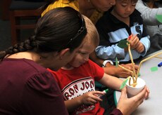 Valerie Billau helps her son Ethan create a family tree during the Children's Story Hour and Craft Time on Charleston AFB Nov. 3. The library holds these sessions two times a week. Some of the crafts assist the children in developing their cognitive skills. (U.S. Air Force photo/Senior Airman Katie Gieratz)(RELEASED)
