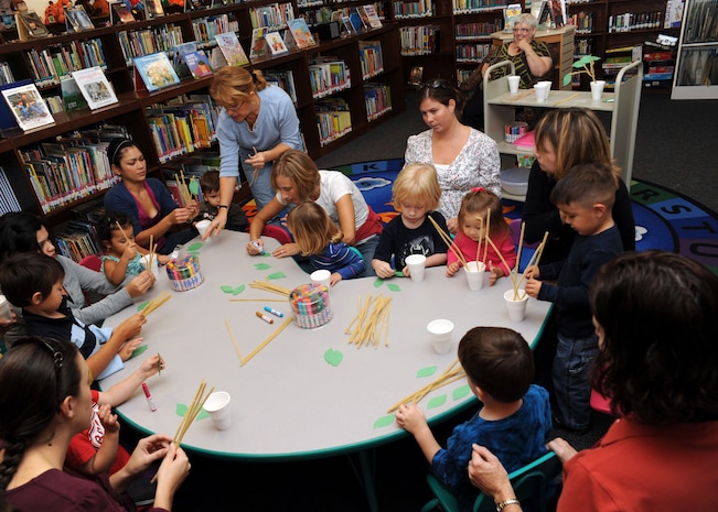 Carmen Alonso instructs children on what to do during craft time at the base library here Nov. 3. Together with their parents, the children made "family trees" as part of Air Force Family Week. Ms. Alonso is a library technician with the 437th Force Support Squadron. (U.S. Air Force photo/Senior Airman Katie Gieratz)
