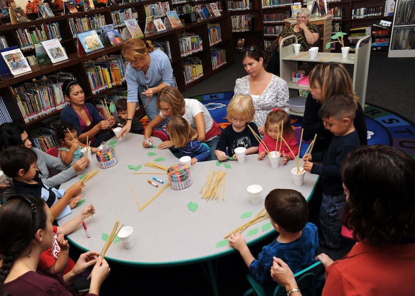 Carmen Alonso instructs children on what to do during craft time at the base library here Nov. 3. Together with their parents, the children made "family trees" as part of Air Force Family Week. Ms. Alonso is a library technician with the 437th Force Support Squadron. (U.S. Air Force photo/Senior Airman Katie Gieratz)