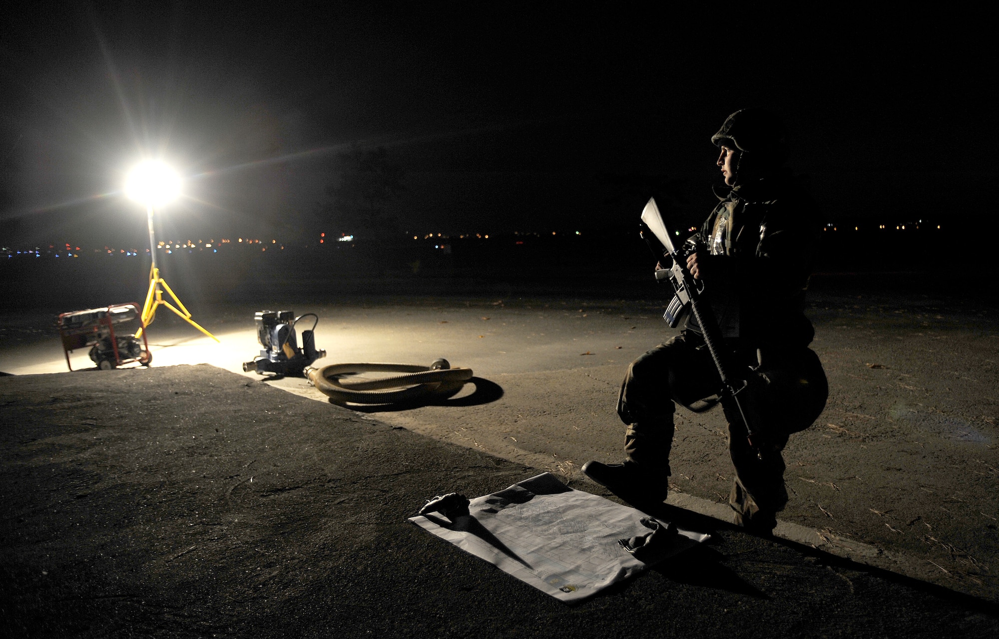 Senior Airman Tyler Peterson checks a map of the area after a simulated water main rupture near the flightline during operational readiness exercise Beverly Midnight 09-02, Nov. 3, at Osan Air Base, Republic of Korea.  Airman Peterson is assigned to the 51st Civil Engineer Squadron. (U.S. Air Force photo/Staff Sgt. Brian Ferguson)




