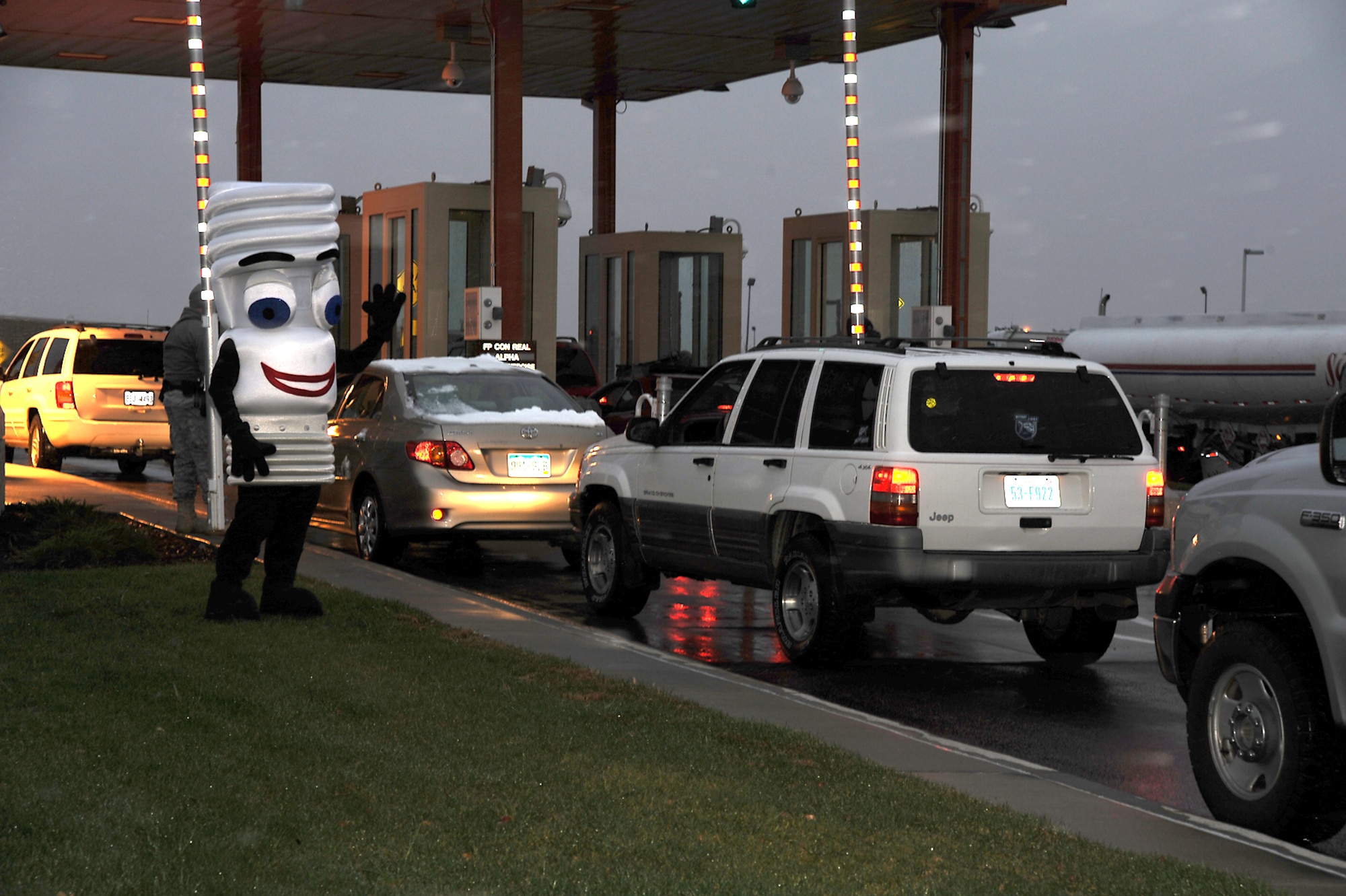 “Pete Light,” the base’s energy awareness mascot, braves the cold and snow to promote Energy Awareness Month at the West Gate Oct. 21. Peterson’s average electric bill is $400,000 per month, and energy officials encourage everyone to practice energy conservation. (Air Force photo by Roberta McDonald)