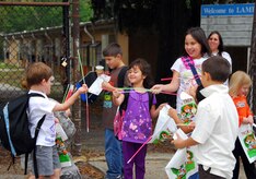 Stacey Scott and Ashley Scott, right, show off their glow-in-the-dark necklaces provided by the 437th Airlift Wing Safety Office at the Lamb's Elementary School gate here Oct. 30. Each year before Halloween, the 437 AW performs a Halloween safety sendoff for local students. Along with many existing programs, this service helps to enhance the lives of those in the Air Mobility Command family and increases family safety awareness during the Year of the Air Force Family. Stacey and Ashley are daughters of Master Sgt. Donald Scott who is with the 437th Maintenance Operations Squadron. (U.S. Air Force photo/Staff Sgt. Daniel Bowles)