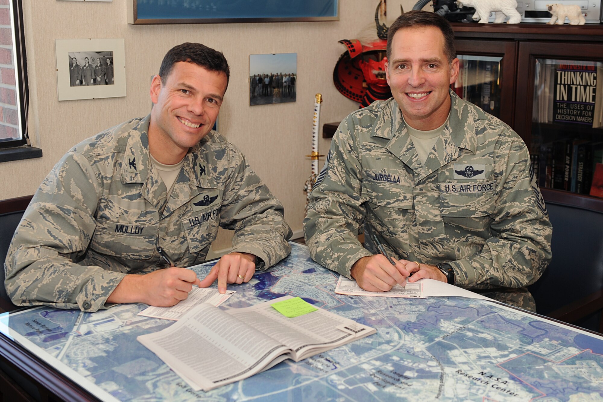 LANGLEY AIR FORCE BASE, Va. -- Col Matt Molloy, 1st Fighter Wing commander, and Chief Master Sgt Kevin Jurgella, 1st FW command chief, sign checks to donate money to Langley’s 2009 Combined Federal Campaign here Nov. 3. The program provides federal employees with an opportunity to support local, national and international charities. This year team Langley is looking to raise more than $436,000, the CFC runs from Oct. 5 to Nov. 20. (U.S. Air Force photo/Airman 1st Class Gul Crockett)

