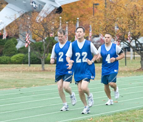 Hanscom leaders keep pace on the track as they fulfill the 1.5 mile timed-run portion of their physical training tests. Lt. Gen. Ted Bowlds, Electronic Systems Center commander; Col. Lee Pritchard, 66th Air Base Wing IMA to the commander and Master Sgt. John Carbon, 66th Security Forces Squadron first sergeant, participated in a PT test session held for base leadership on Oct. 30.  (U.S. Air Force photo by Mark Herlihy)