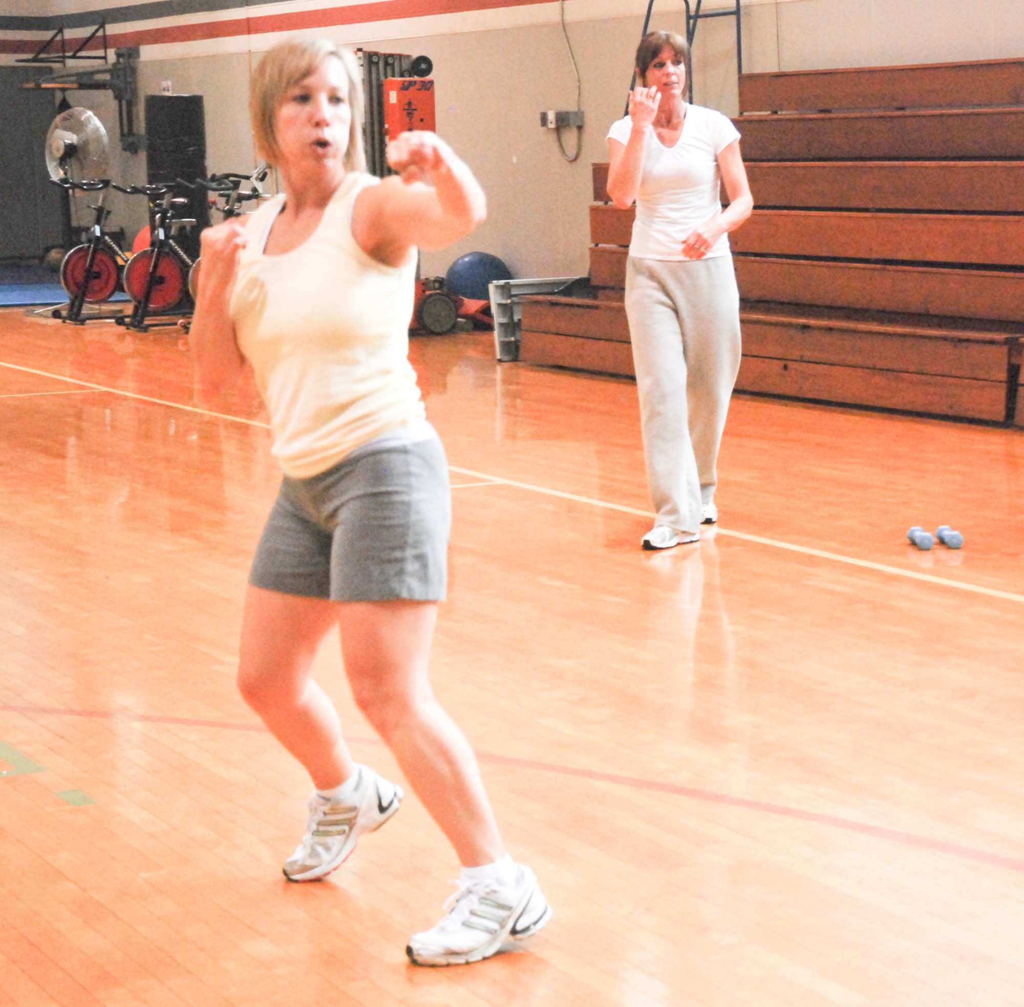 Maj. Kayla Sailer, 94th Communications Flight commander, and Jeannie Goodwin, 94th CF administrative assistant, work on their boxing moves while doing a group workout video at the Dobbins fitness center Nov. 2. The fitness center now offers free group workouts every Monday and Friday at 10 a.m. Workout videos are available for use at anytime throughout the week. (U.S. Air Force photo/Erin Tindell)
 