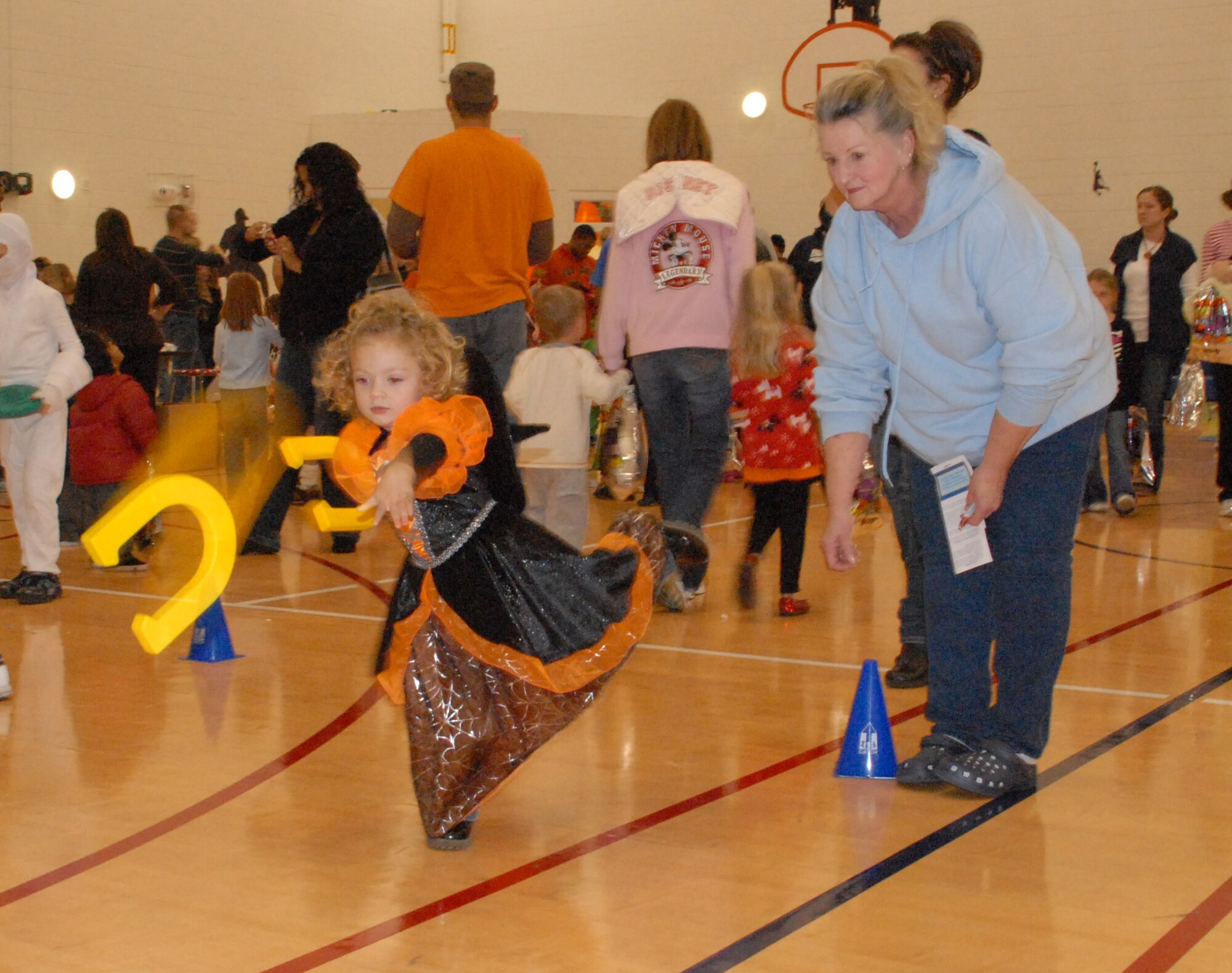 Hunter Reeder, the 2-year-old granddaughter of Wendy Jones, Youth Center schoolage program assistant, tosses horseshoes during the Harvest Festival at the Youth Center Oct. 30.  The Harvest Festival was the kick-off event for the Year of the Air Force Family.  For more information on Year of the Air Force Family, visit http://www.af.mil/yoaff.  (U.S. Air Force photo/Staff Sgt. Chad Padgett)