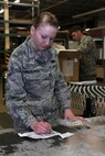 MINOT AIR FORCE BASE, N.D. -- Airman 1st Class Kara Kwiatkowski, 5th Logistics Readiness Squadron receiving journeyman, verifies new items received here, Oct. 29. Receiving journeymen ensure all unclassified to top secret packages are distributed to their proper owners. Performing mission requirements such as these is an important aspect to the overall success of Minot AFB. (U.S. Air Force photo by Tech. Sgt. Lee A. Osberry, Jr.)