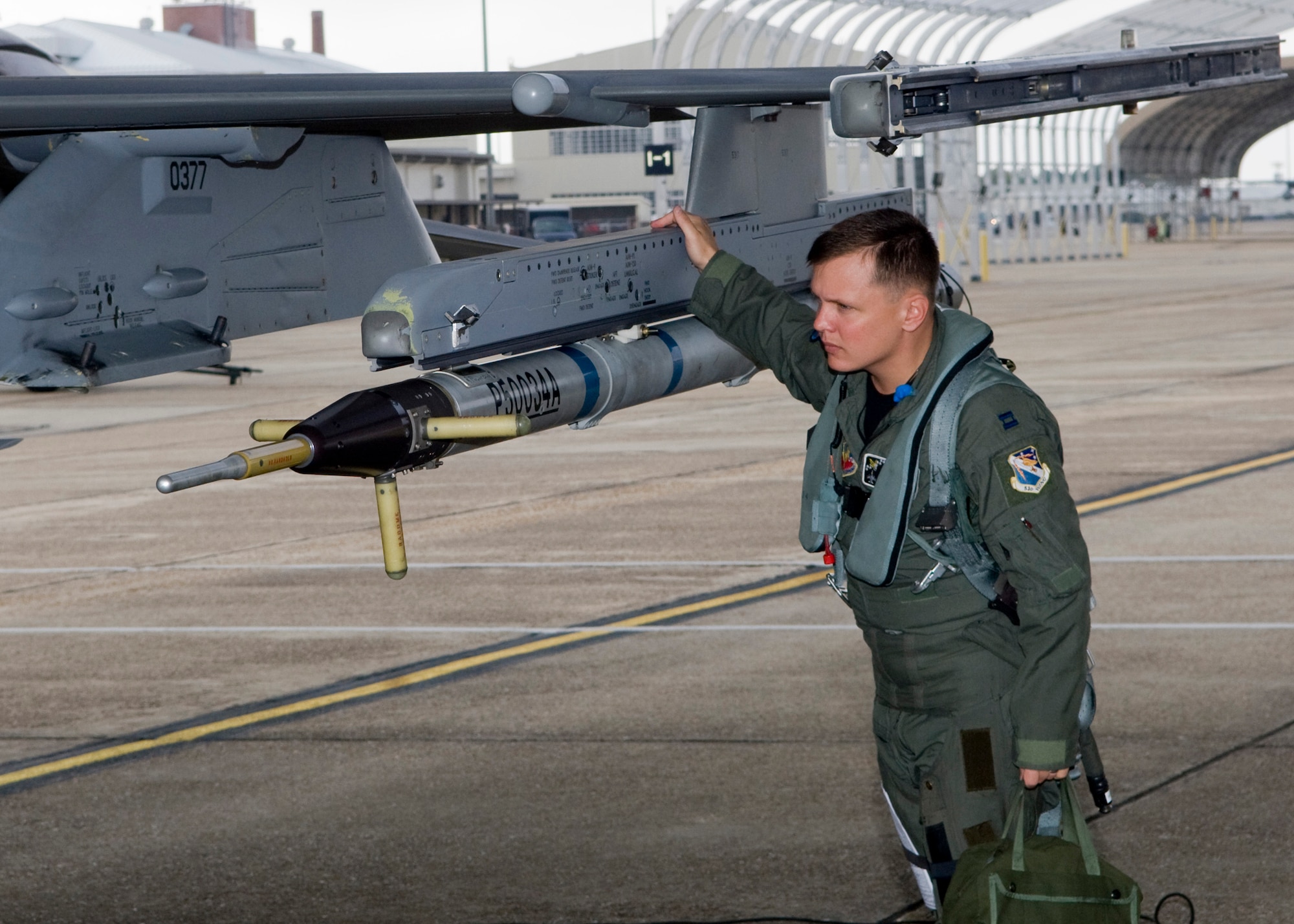 Capt. James Long, 85th Test and Evaluation Squadron, inspects ordnance on his F-16 prior participating in the "Skull War" Oct. 30 at Eglin Air Force Base, Fla.  The "Skull War" is a large scale exercise ran by the 85th TES that provides test pilots the opportunity to fly operationally representative missions with test assets.  (U.S. Air Force photo/ Mike Lewis)