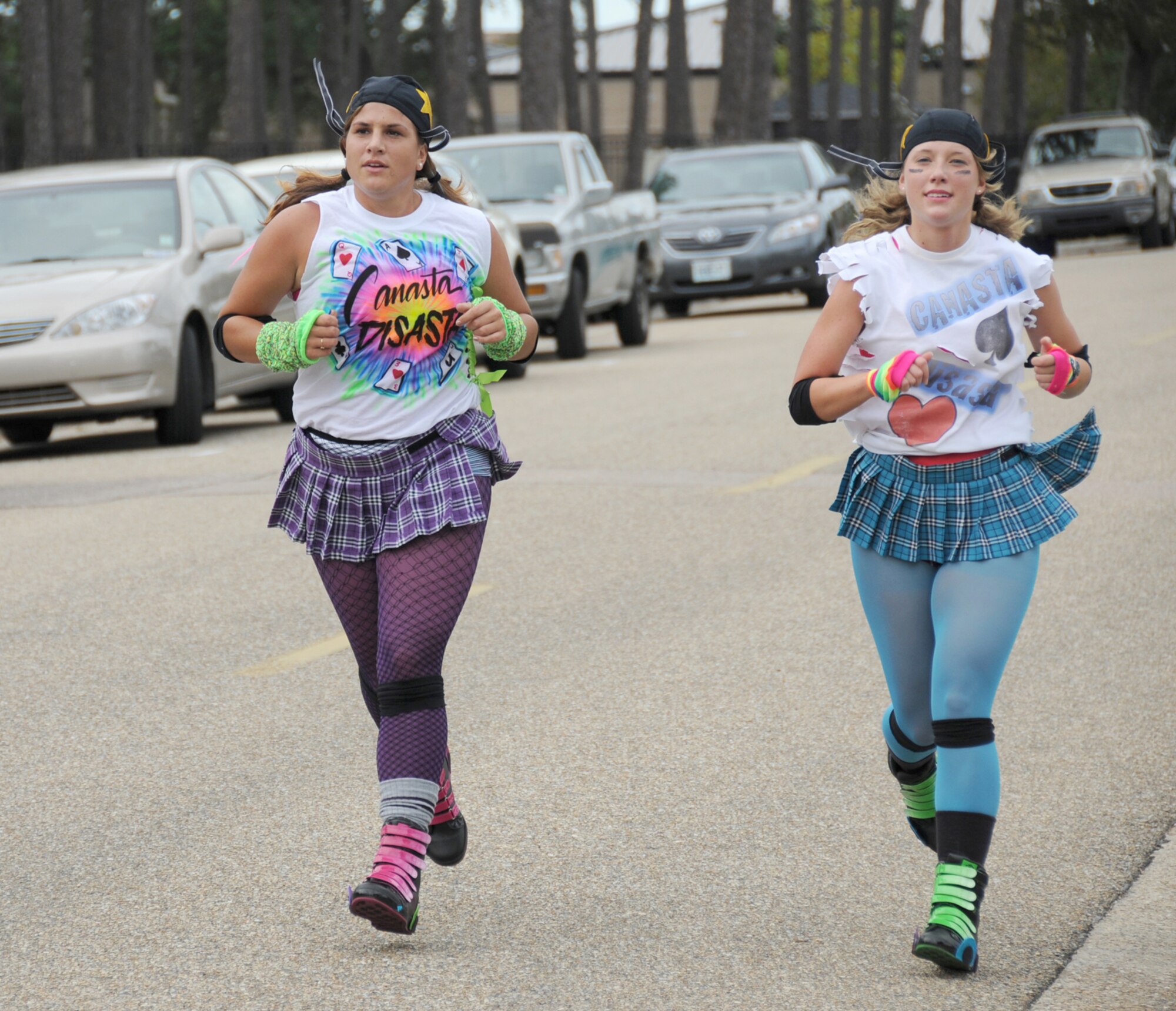 Canasta Disasta Roller Derby Girls Liza Vaccaro, left, and Melissa Meyer, 334th Training Squadron, are the first females to cross the finish line at 37 minutes, 30 seconds.  (U.S. Air Force photo by Kemberly Groue)