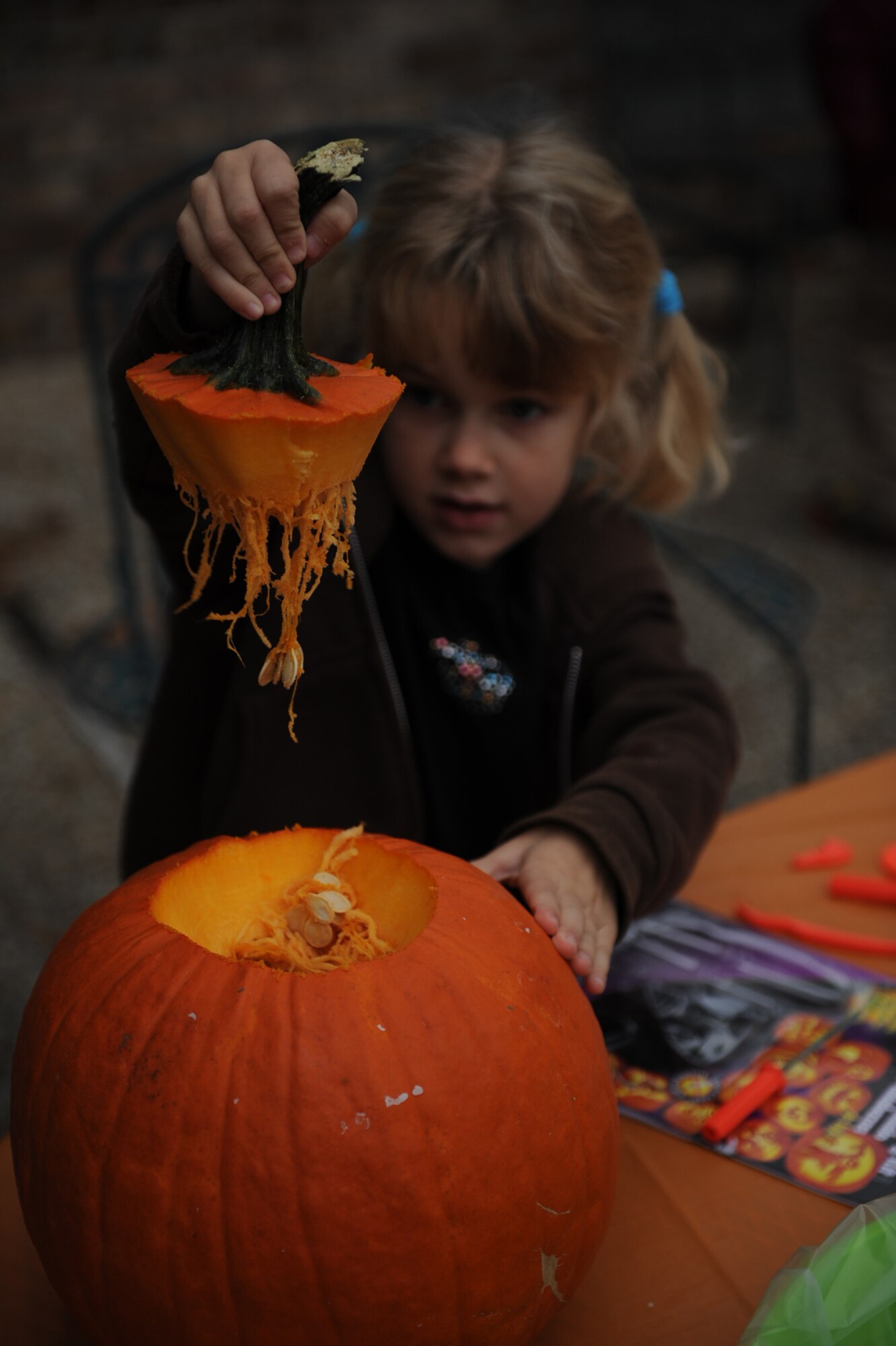 Georgia Kleinwolterink, age 5, holds the stem of her pumpkin after cutting it out during the community center's pumpkin carving event on Seymour Johnson Air Force Base, N.C., Oct. 29, 2009. Georgia is the daughter of Heather and Staff Sgt. Amos Kleinwolterink, a 4th Logistics Readiness Squadron fuels technician.  (U.S. Air Force photo/Senior Airman Ciara Wymbs)