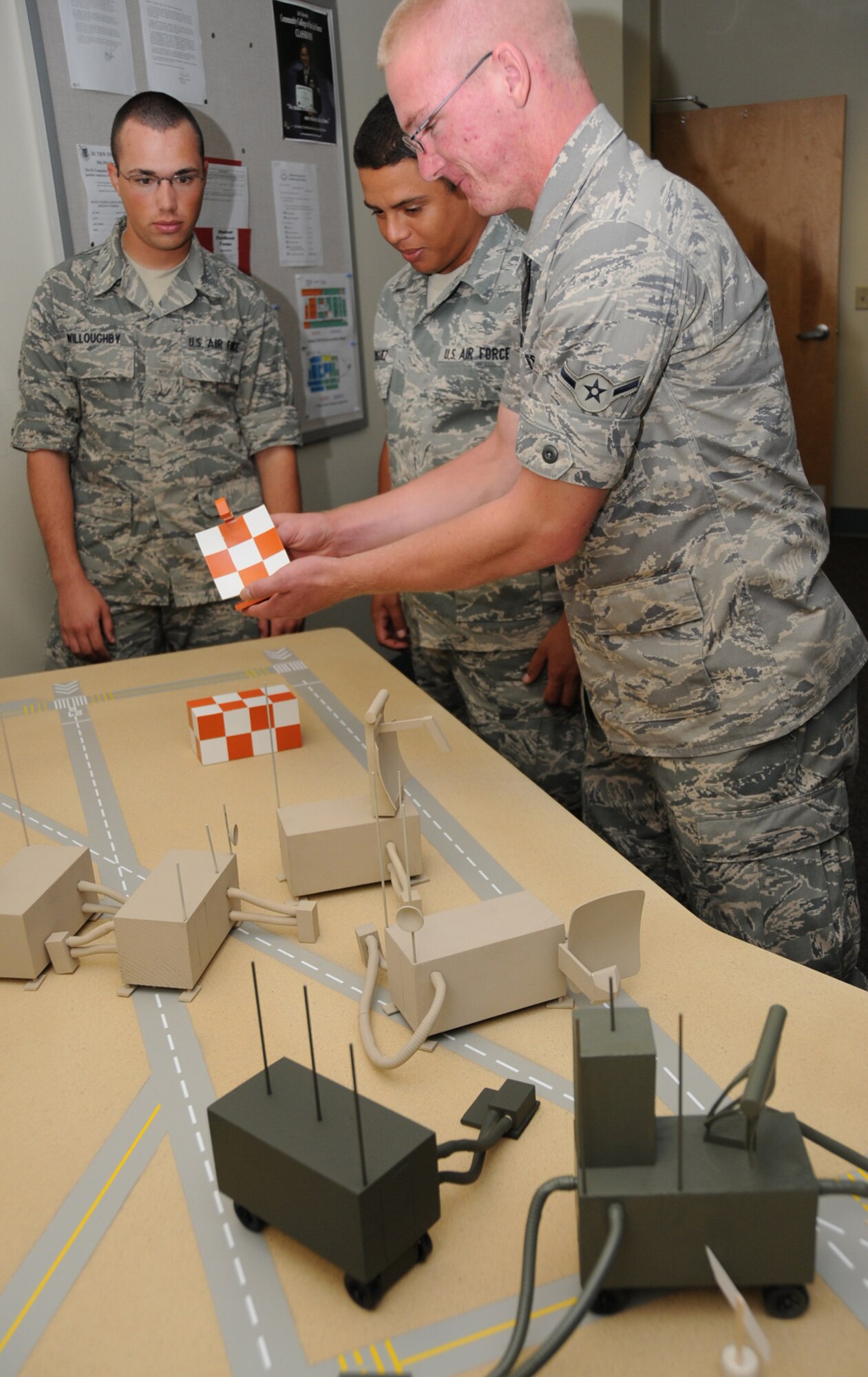 Airman Basic Jered Willoughby, Airman 1st Class Ralphy Rodriguez and Airman Chad Warner, ground radar apprentice course students, look over the new radar models.  (U.S. Air Force photo by Kemberly Groue)