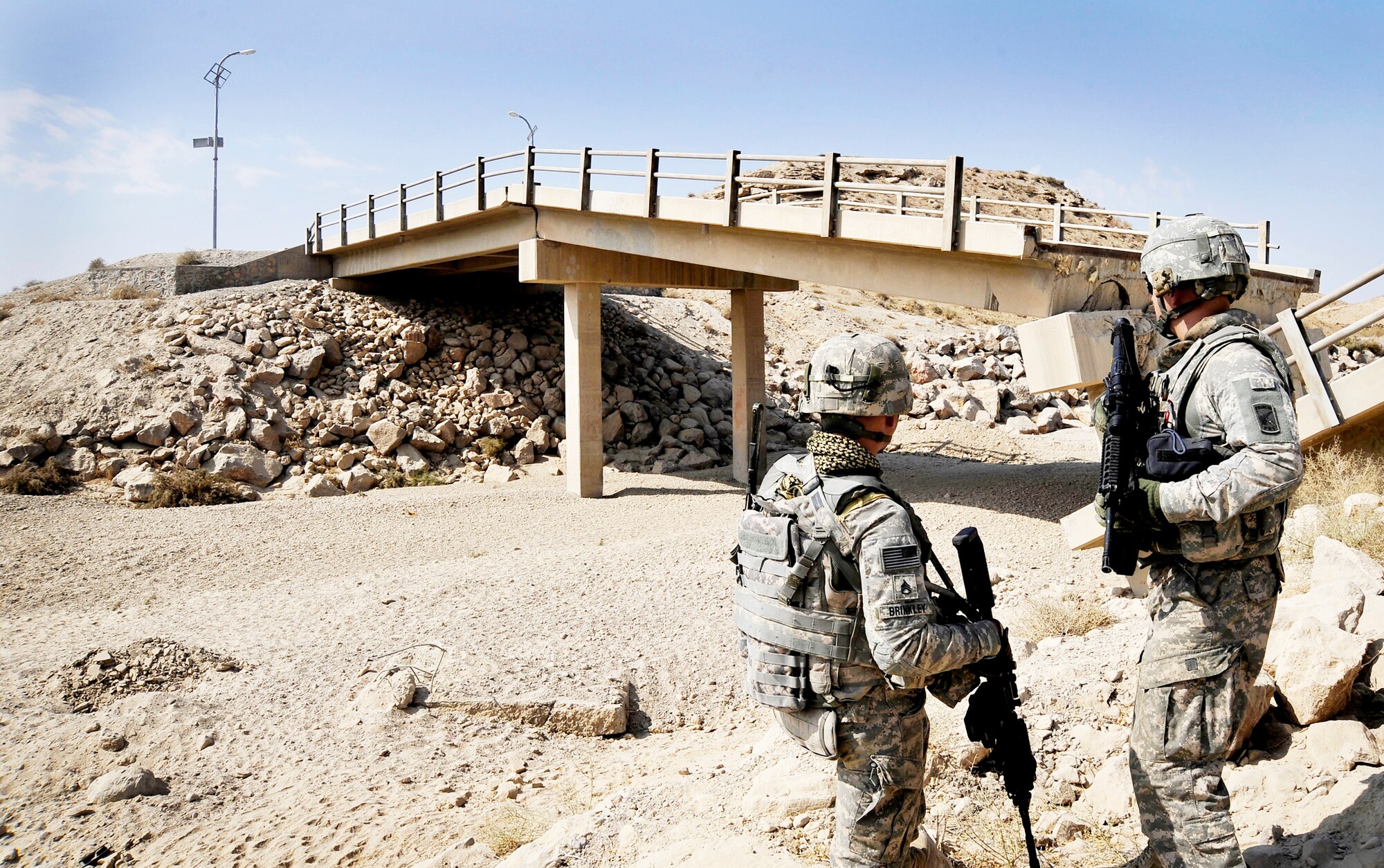 Army Sgt. William Brinkley and Capt. Rick Vermillion speak about a bridge that has received damage from an improvised explosive devices Oct. 23, 2009, in Zabul Province, Afghanistan. The inspections increase safety for the people of Zabul as well as coalition forces while traveling. Sergeant Brinkley is a security forces Soldier assigned to the Provincial Reconstruction Team Zabul, and Captain Vermilion is a PRT engineer. (U.S. Air Force photo/Staff Sgt. Angelita Lawrence) 