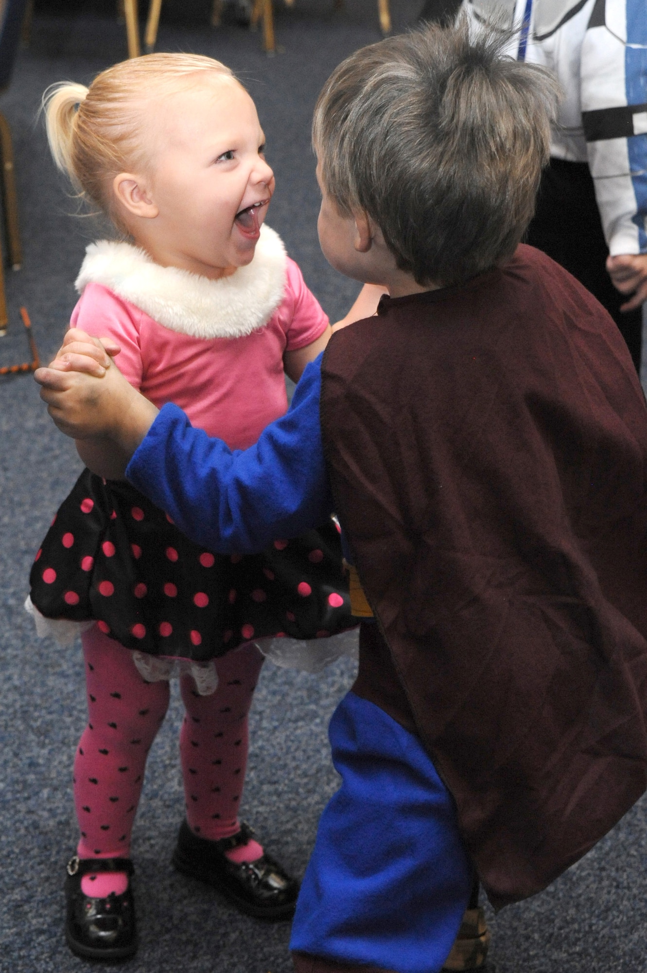 Alexia Hebert, 1, and Liam Hebert, 3, 22nd Aircraft Maintenance Squadron family members, dance the night away during Neowallah Ball at McConnell Air Force Base, Kan., Oct. 30, 2009.  The Neowallah Ball is an annual costume ball for Team McConnell members. (U.S. Air Force photo by Tech. Sgt. Chyrece Campbell)