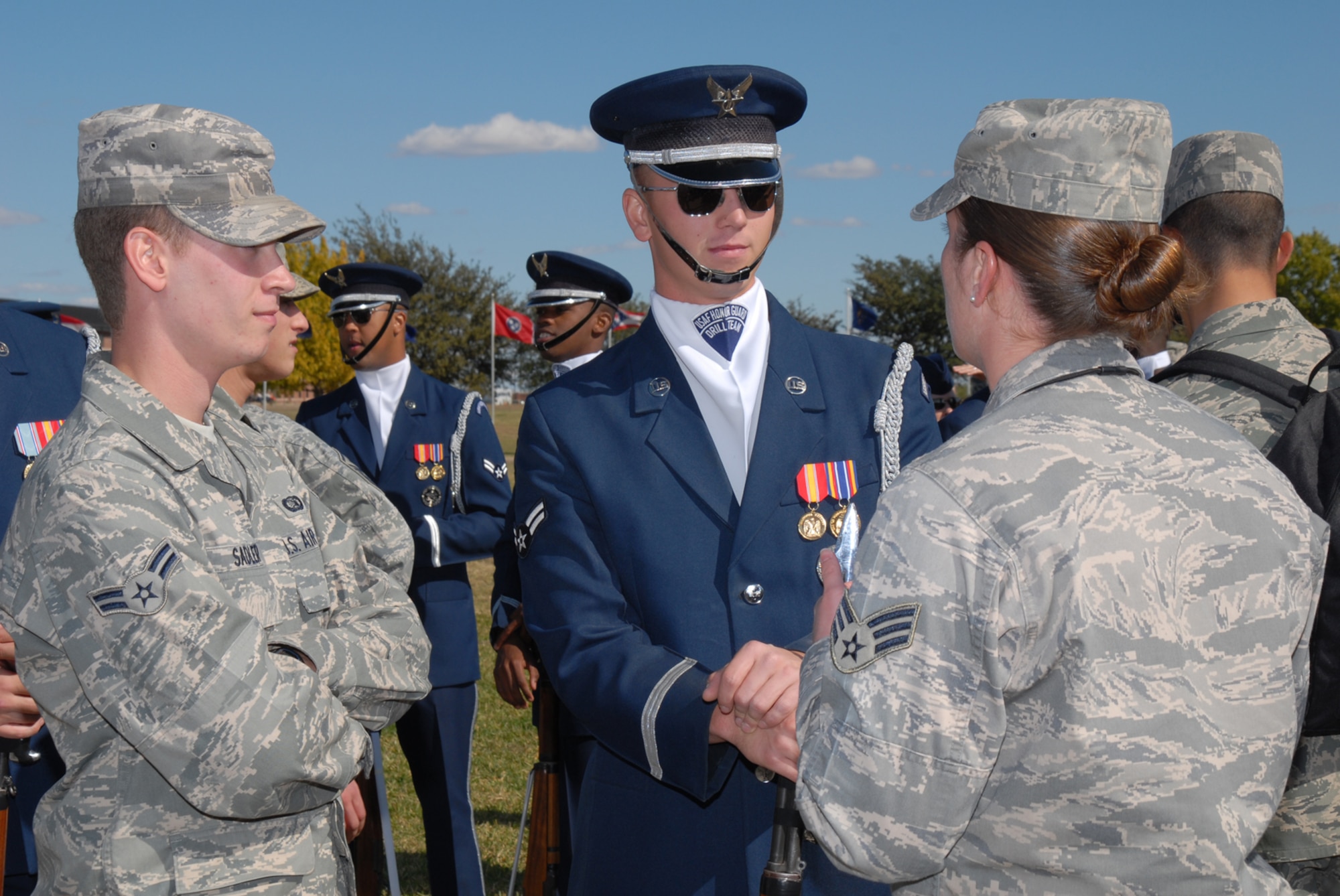 GOODFELLOW AIR FORCE BASE, Texas -- Airman 1st Class Thomas Sadler, 17th Communications Squadron, and Senior Airman Jeanice Smith, 316th Training Squadron instructor, speak with Airman 1st Class Hunter Overaton, U.S. Air Force Honor Guard Drill Team, following a performance by the drill team, Oct. 30, 2009. The Drill Team is the traveling component of the U.S. Air Force Honor Guard and tours worldwide representing all Airmen while showcasing Air Force precision and professionalism. (U.S. Air Force photo/Staff Sgt. Laura R. McFarlane) 
