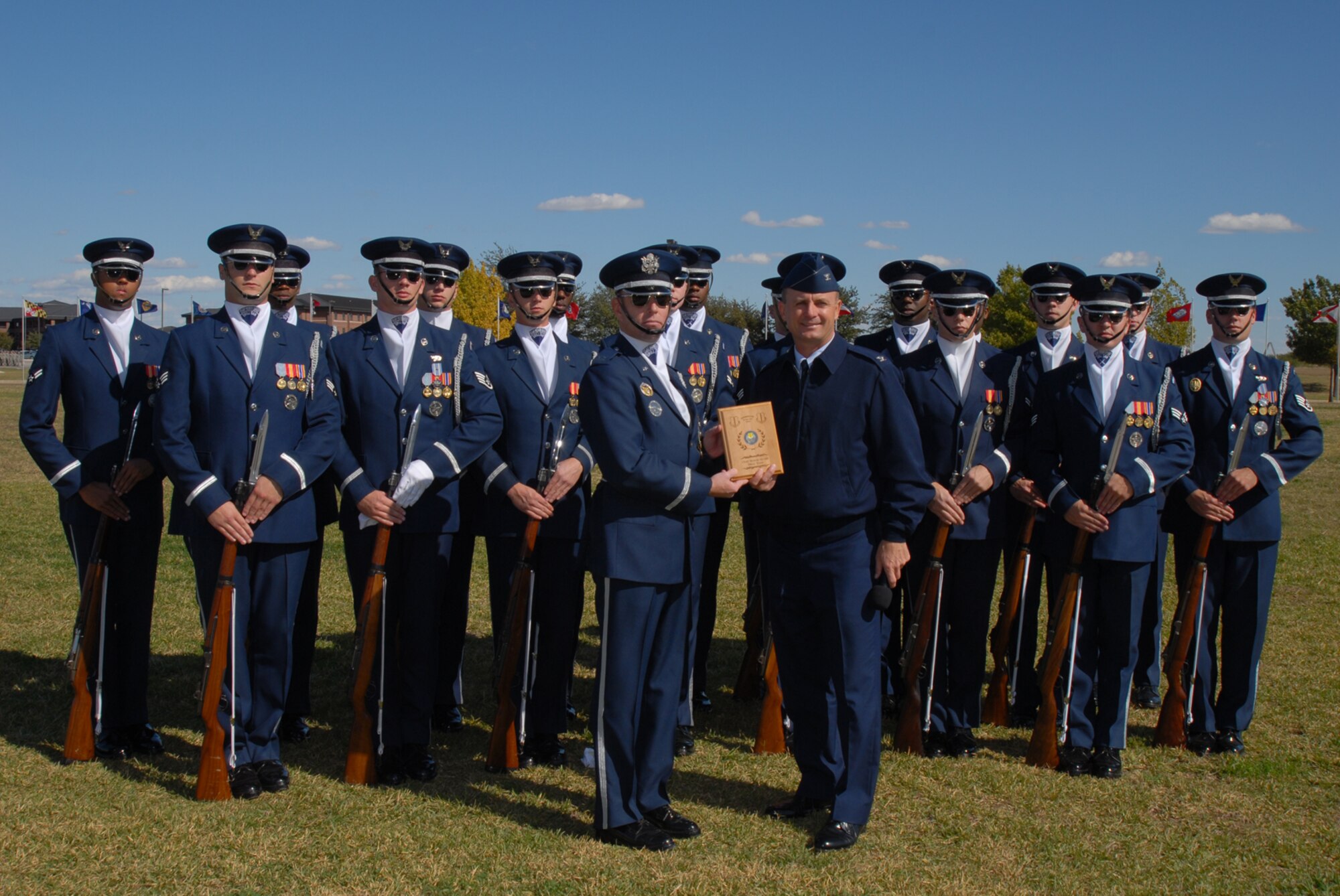 GOODFELLOW AIR FORCE BASE, Texas -- Capt. Michael Fanton, on behalf of the U.S. Air Force Honor Guard Drill Team, accepts a plaque from Col. Guy Parker, 17th Mission Support Squadron commander, following a performance at the parade grounds, Oct. 30, 2009. The Drill Team is the traveling component of the U.S. Air Force Honor Guard and tours worldwide representing all Airmen while showcasing Air Force precision and professionalism. (U.S. Air Force photo/Staff Sgt. Laura R. McFarlane) 
